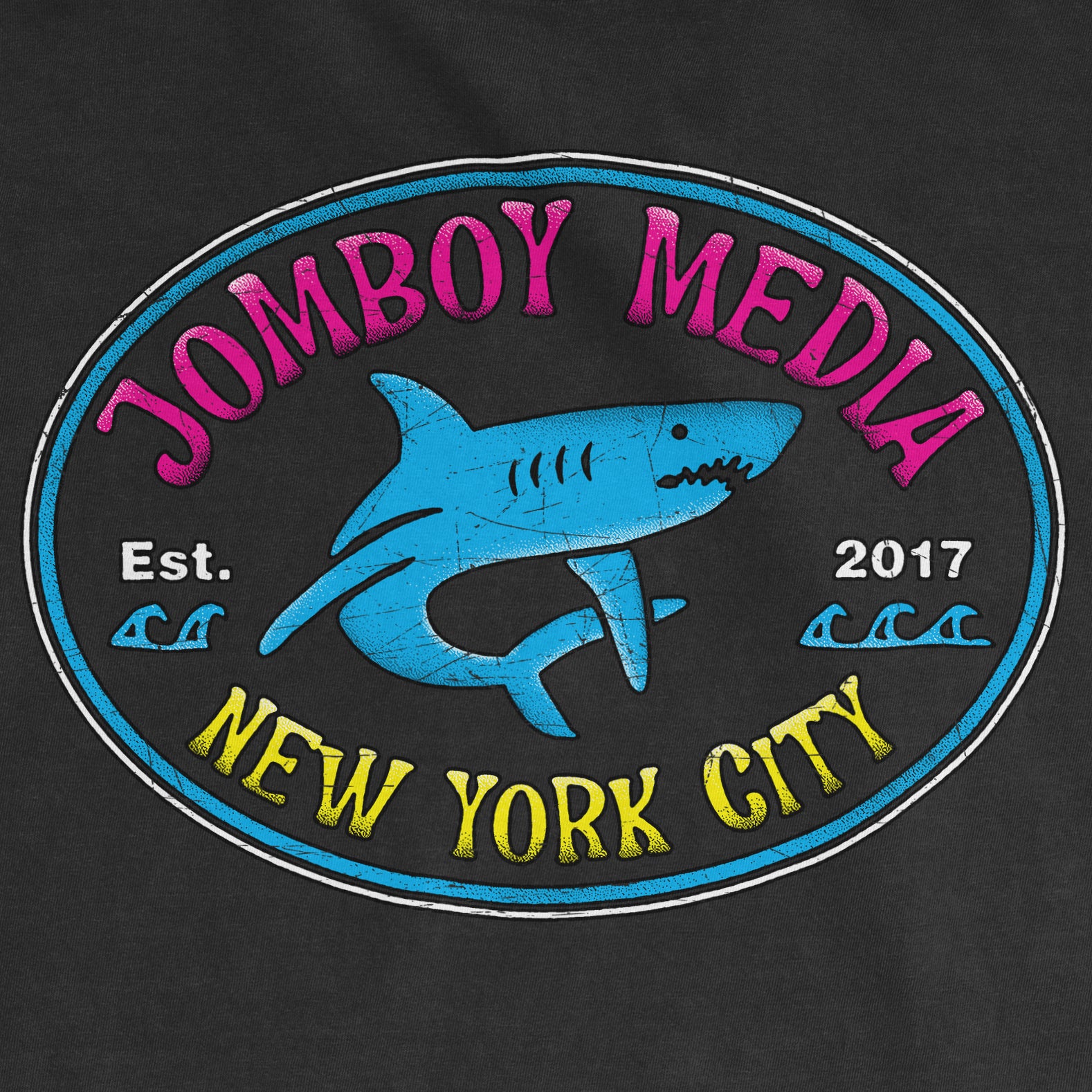 Black Comfort Colors tee featuring a colorful "Jomboy Media" logo with a shark graphic, "New York City" text, and establishment year 2017.
