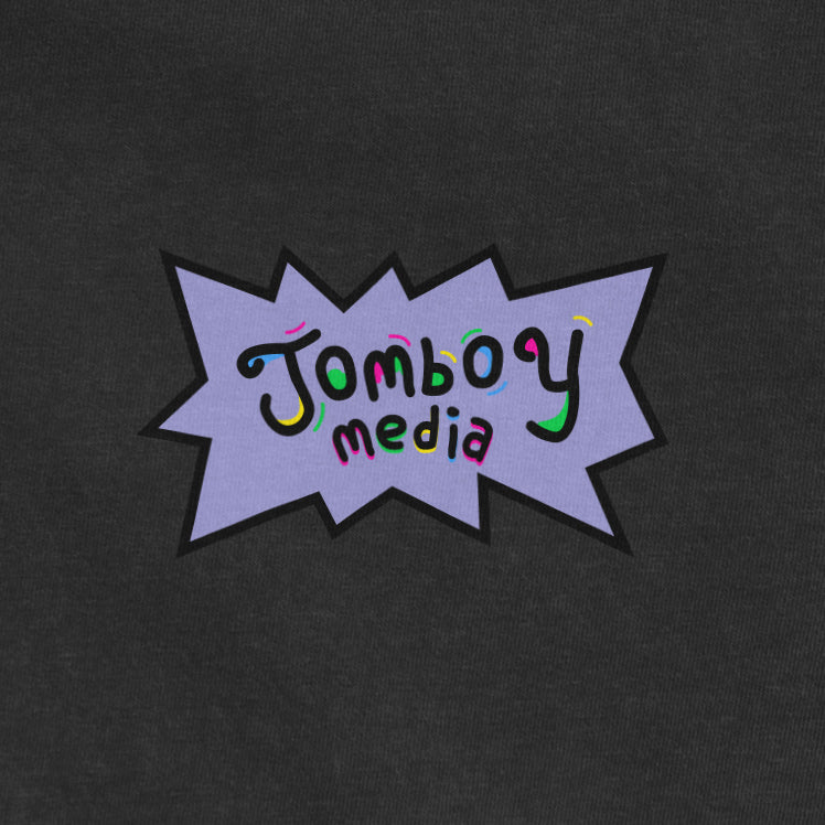 Comfort Colors tee featuring a colorful "Jombo Media" logo with playful, vibrant text and a purple comic-style background.