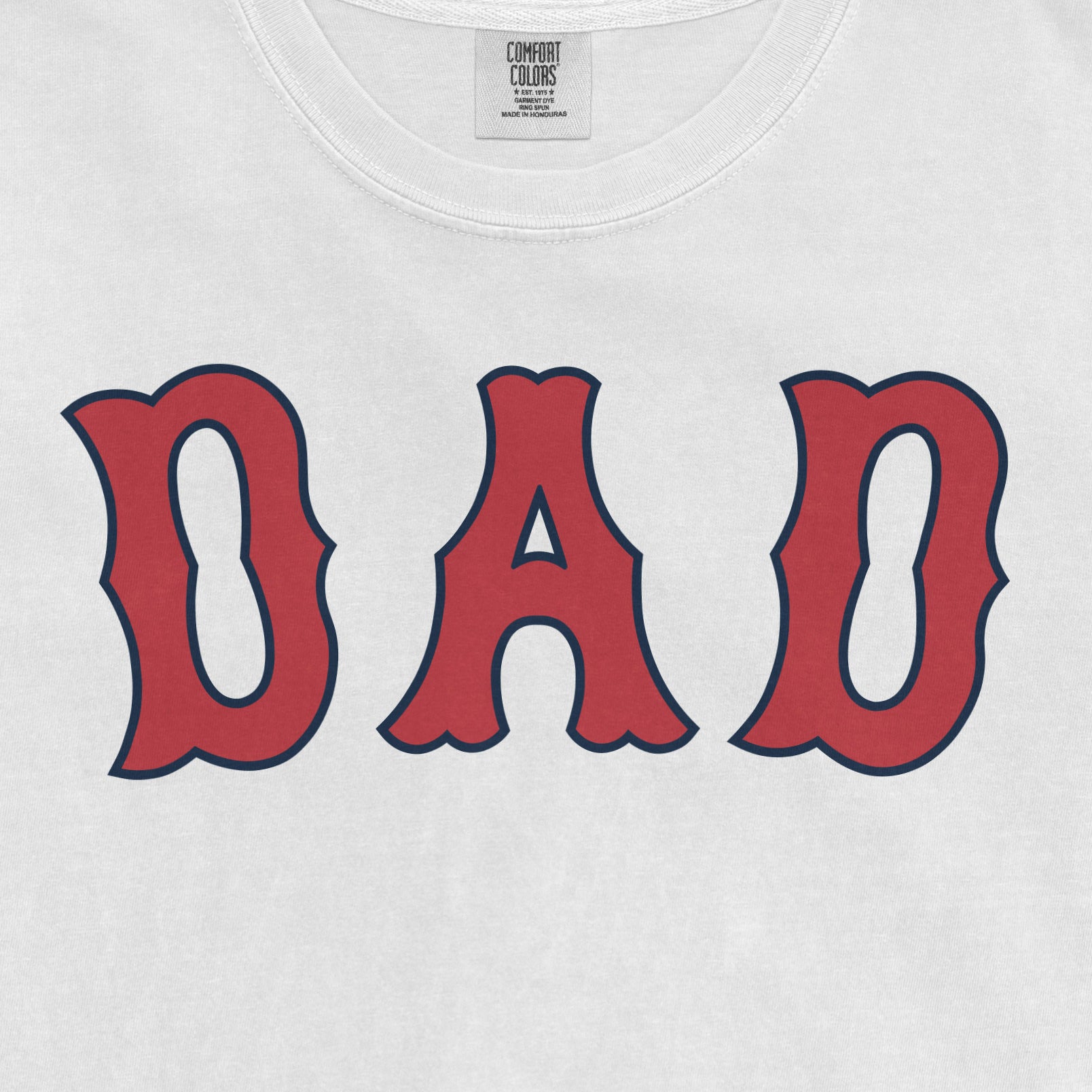 White Comfort Colors T-shirt with "Dad" in large red and navy blue lettering, celebrating Boston baseball dads.