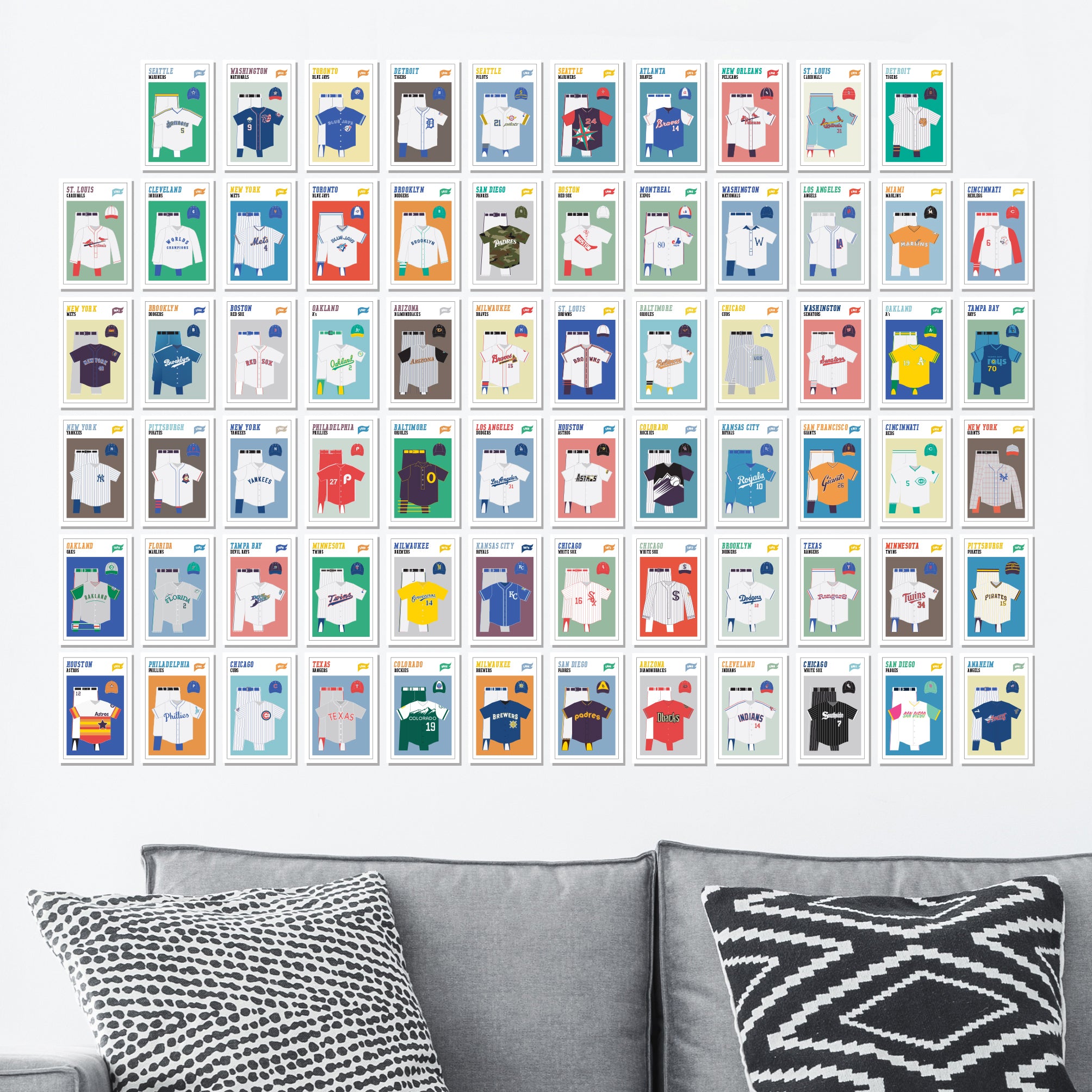 Collage of various baseball uniforms representing different teams, displayed on a wall above a sofa with patterned pillows.