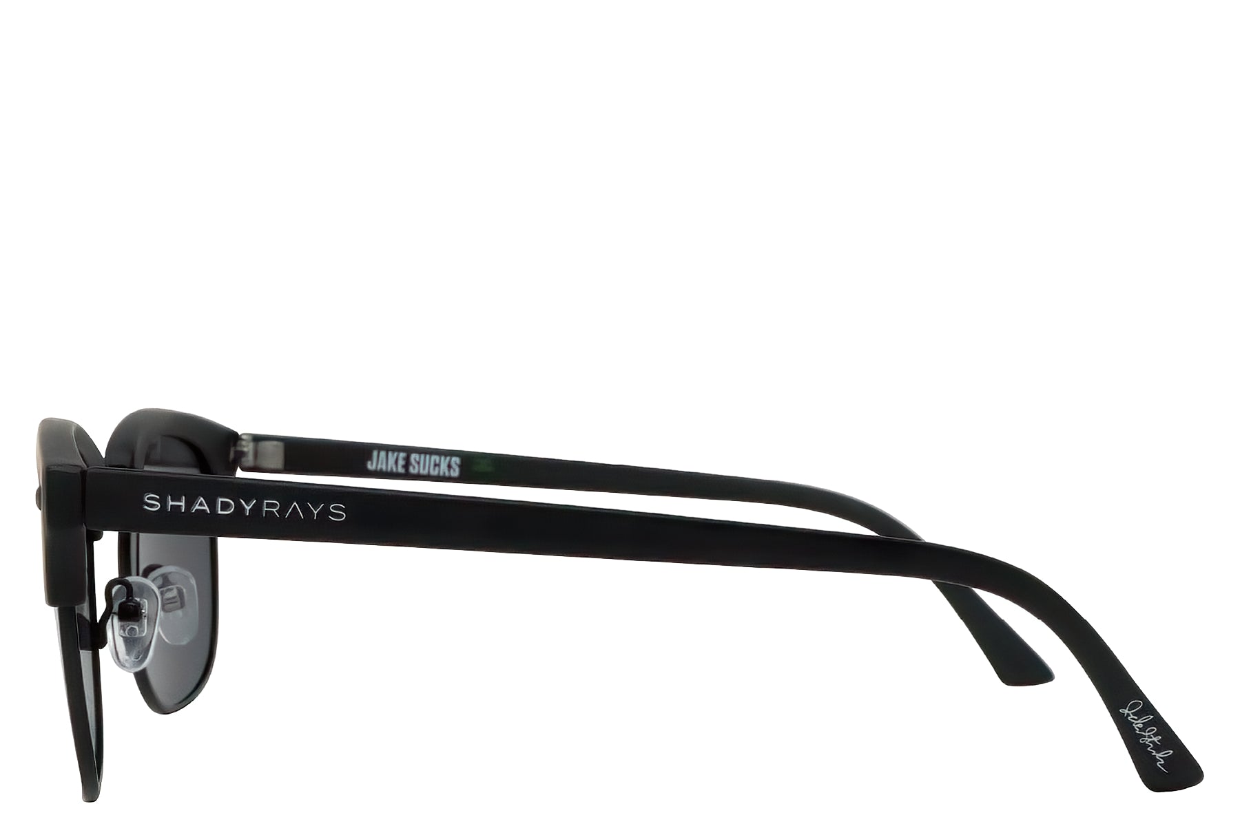 Black Shady Rays sunglasses called "The Jake" with "Jake Sucks" on the temple, featuring dark lenses and a sleek design.