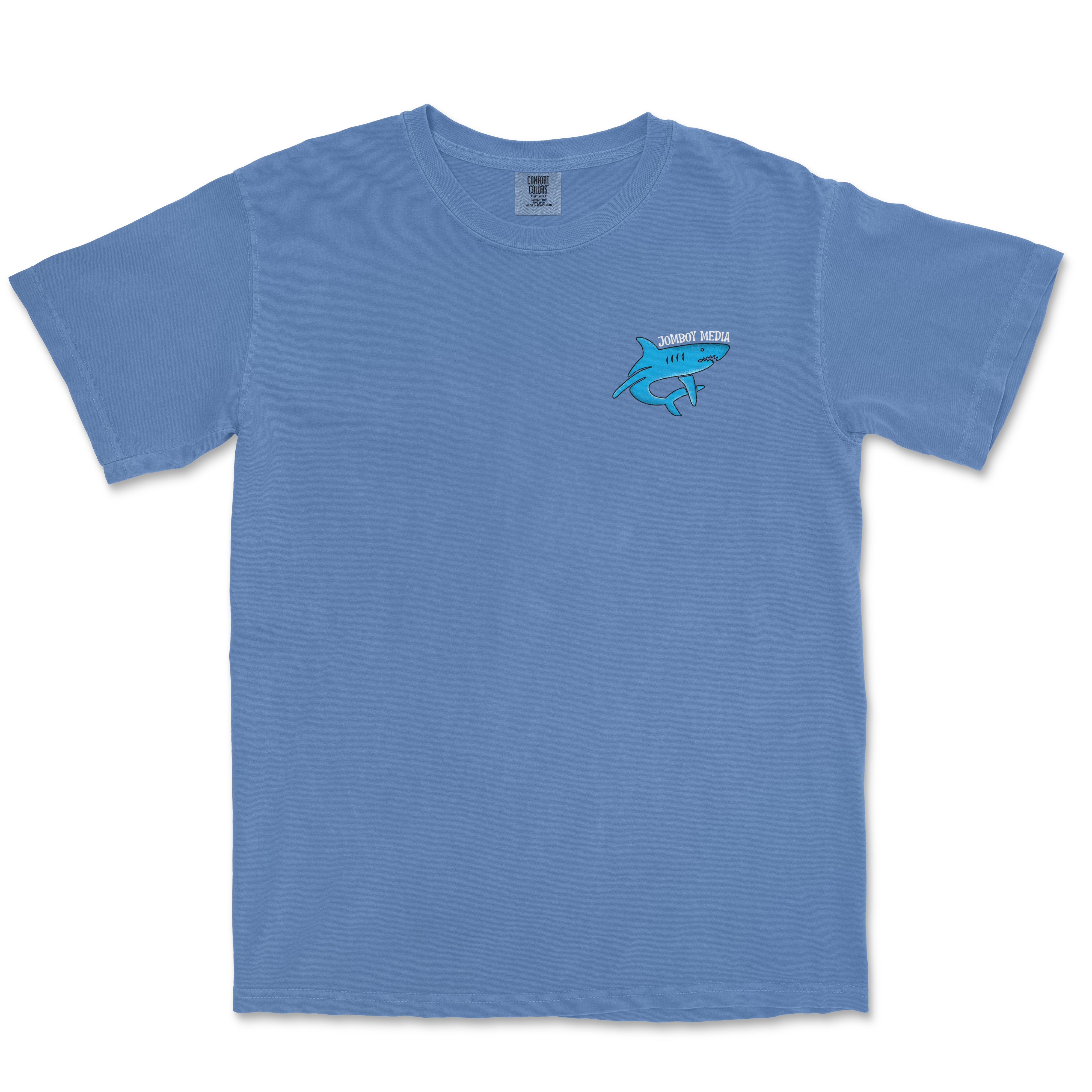 Blue Comfort Colors T-shirt with a small shark graphic and "Jomboy Media" text on the front left chest area.