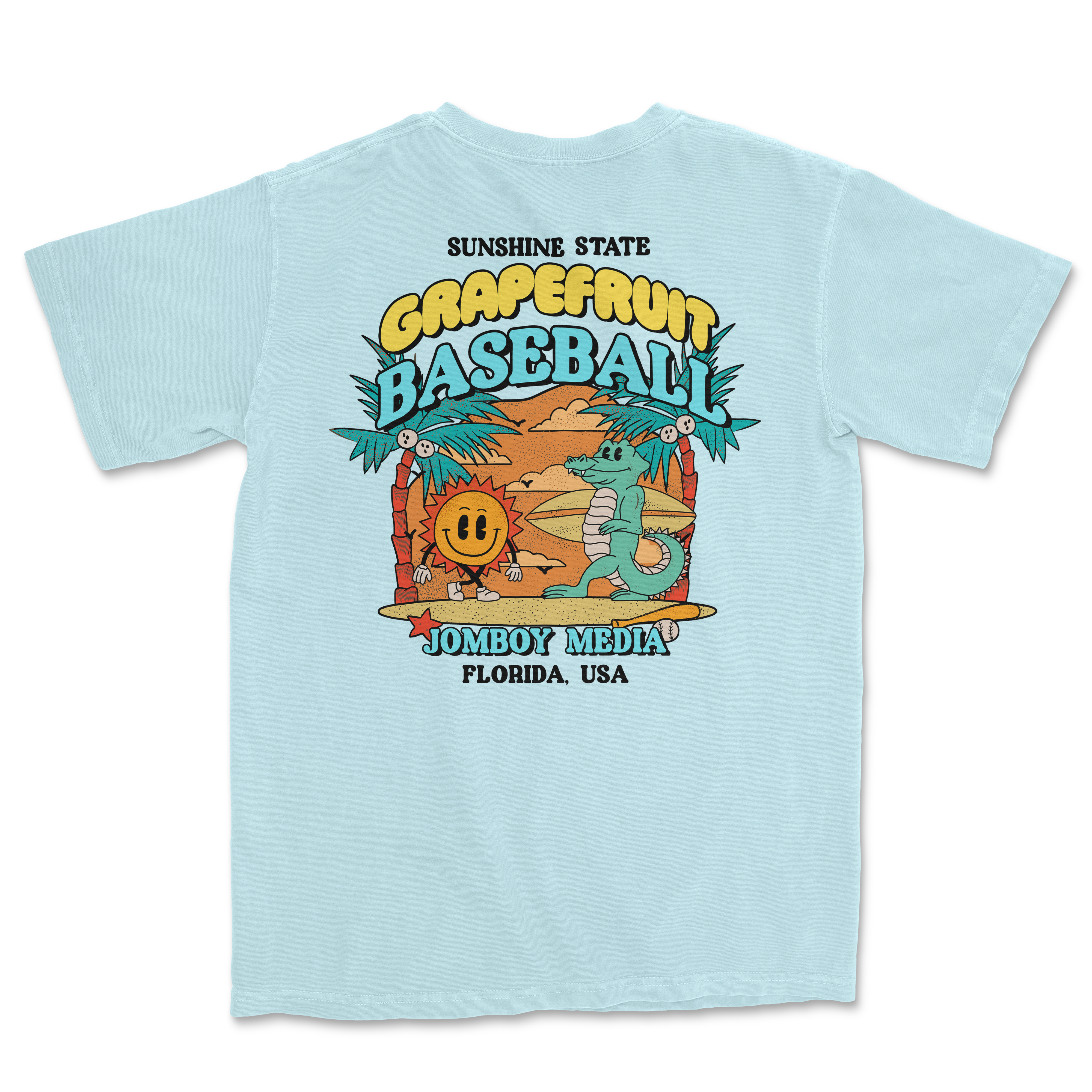 Light blue Comfort Colors T-shirt featuring a colorful grapefruit-themed baseball design with palm trees, a smiling sun, and a crocodile.