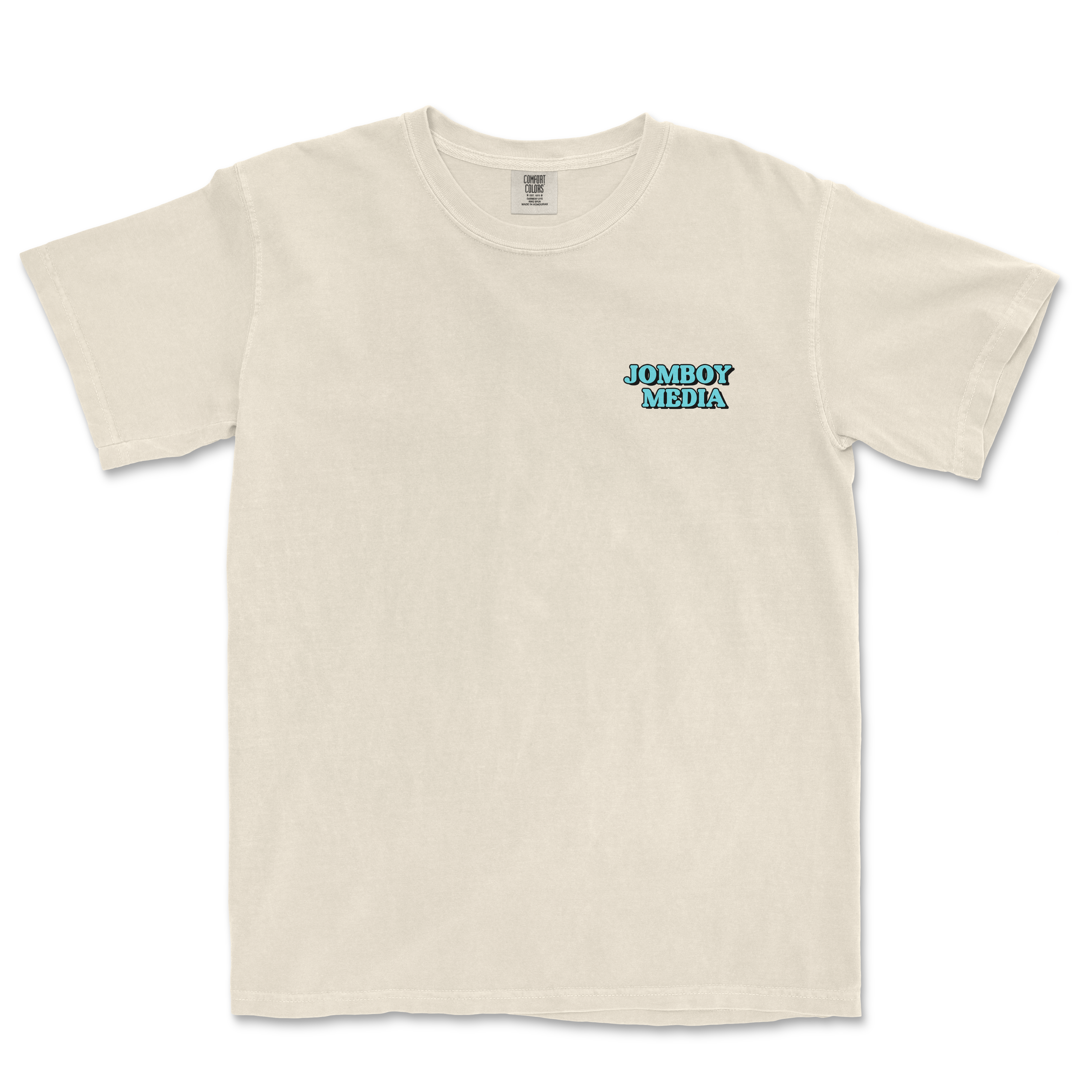 Beige Comfort Colors T-shirt with "JOMBOY MEDIA" in blue and black text on the left chest area.
