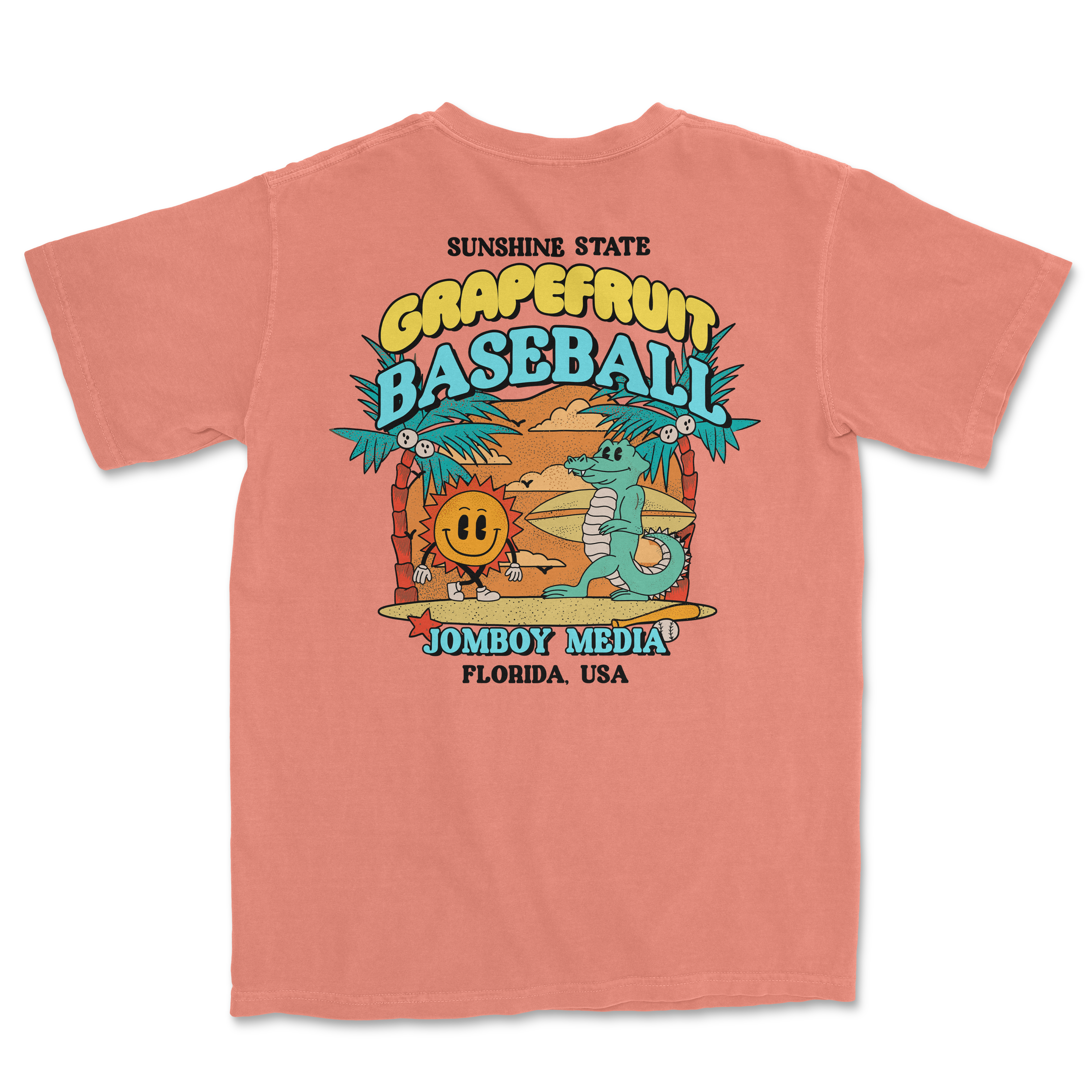 Pink Comfort Colors T-shirt featuring a colorful graphic of a smiling sun and crocodile at a beach with palm trees, promoting grapefruit baseball in Florida.