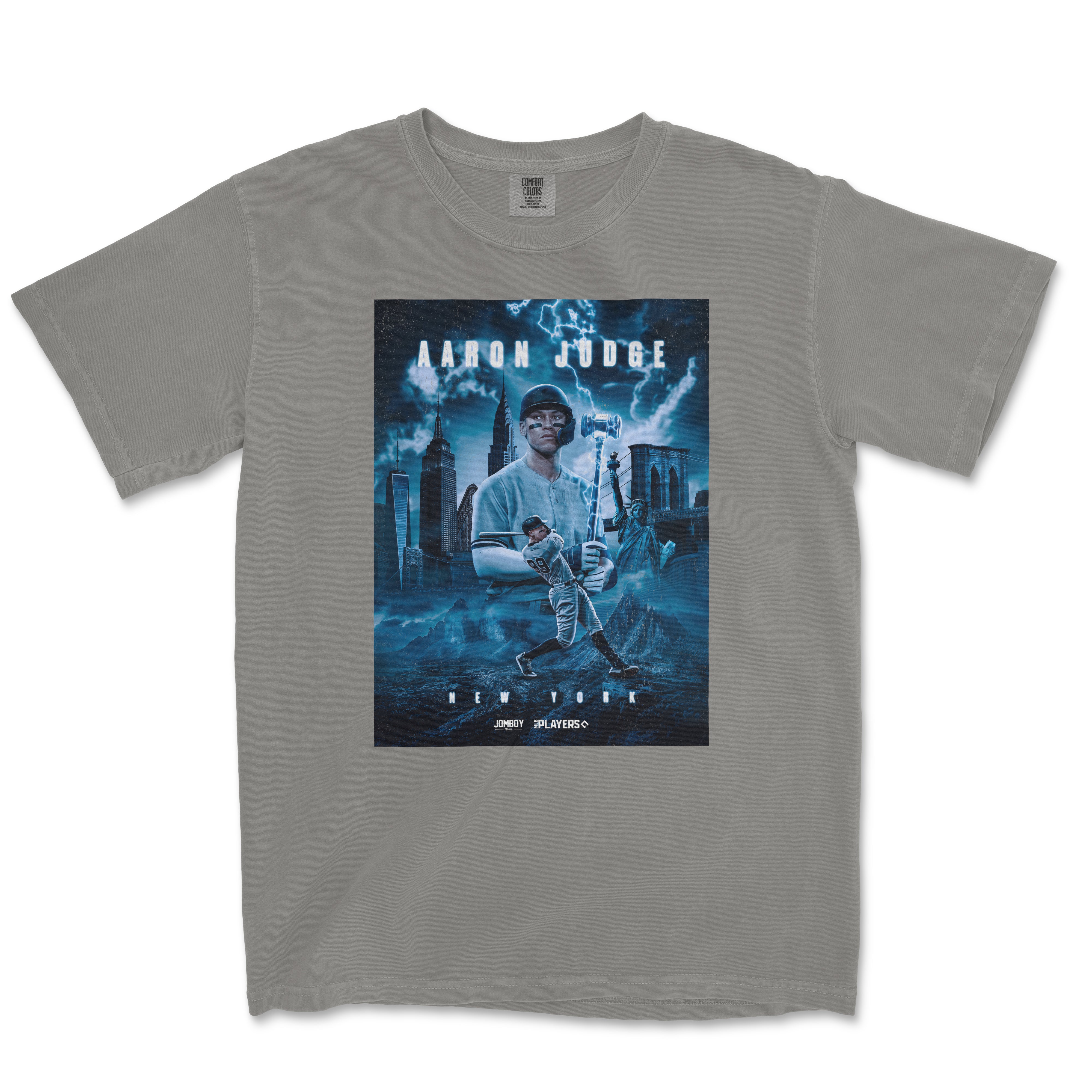 Gray Comfort Colors T-shirt featuring a graphic design of Aaron Judge as a superhero in NYC, with lightning and cityscape background.