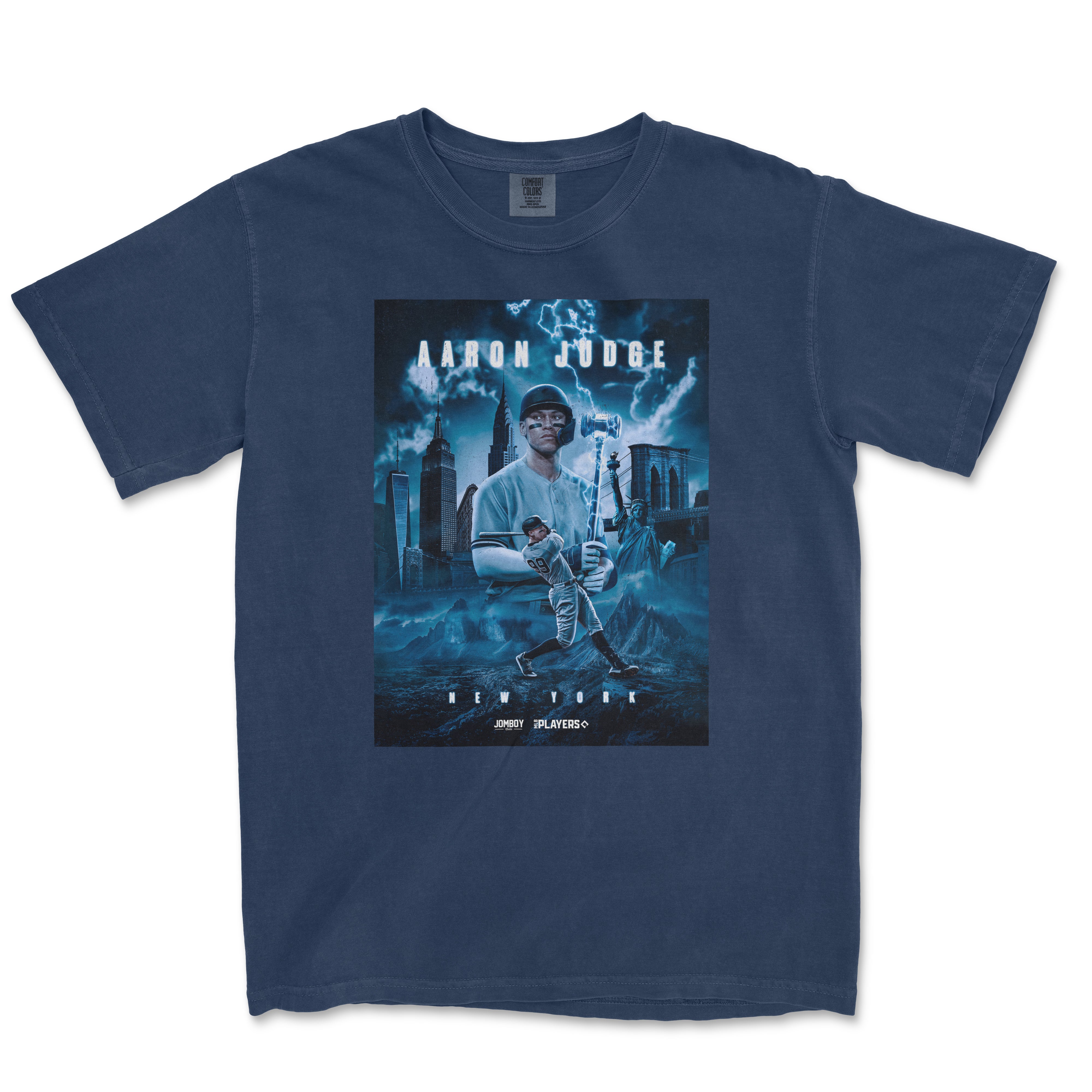 Blue Comfort Colors T-shirt featuring a graphic design of Aaron Judge as a superhero, with NYC skyline, lightning, and baseball elements.