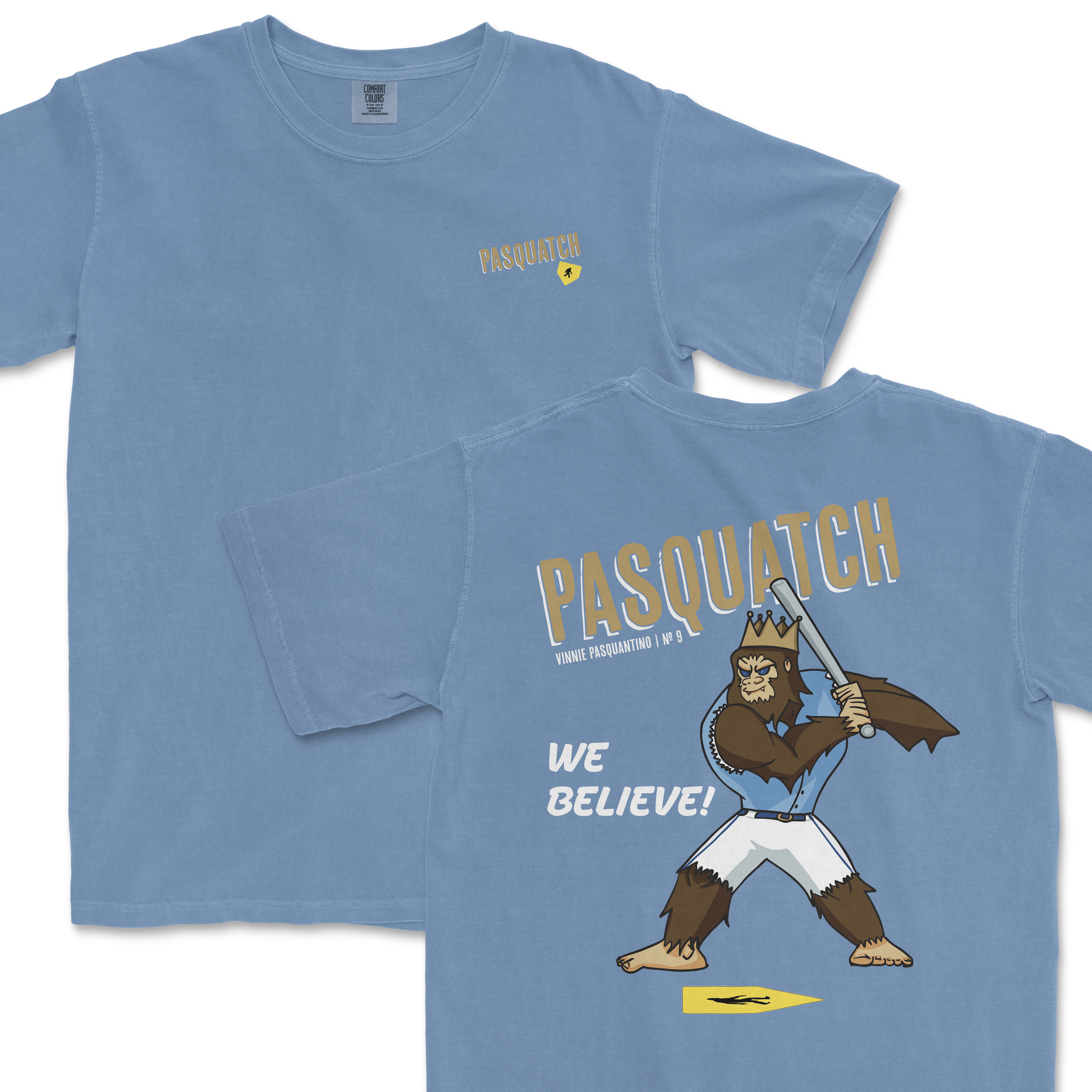 Light blue t-shirt featuring a cartoon Sasquatch in a crown holding a sword, with "Pasquatch" and "We Believe!" text on the back.