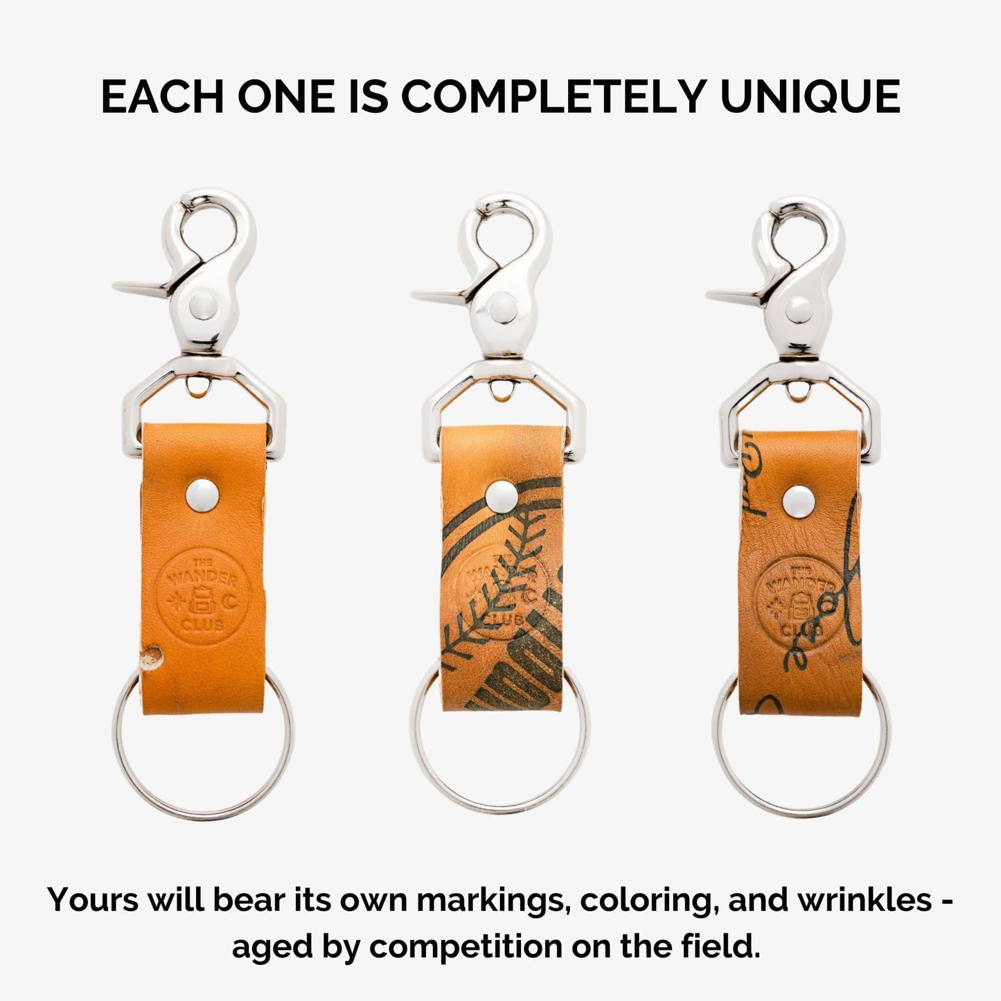 Three leather and metal keychains with unique markings, featuring a baseball glove design and a lobster clasp.