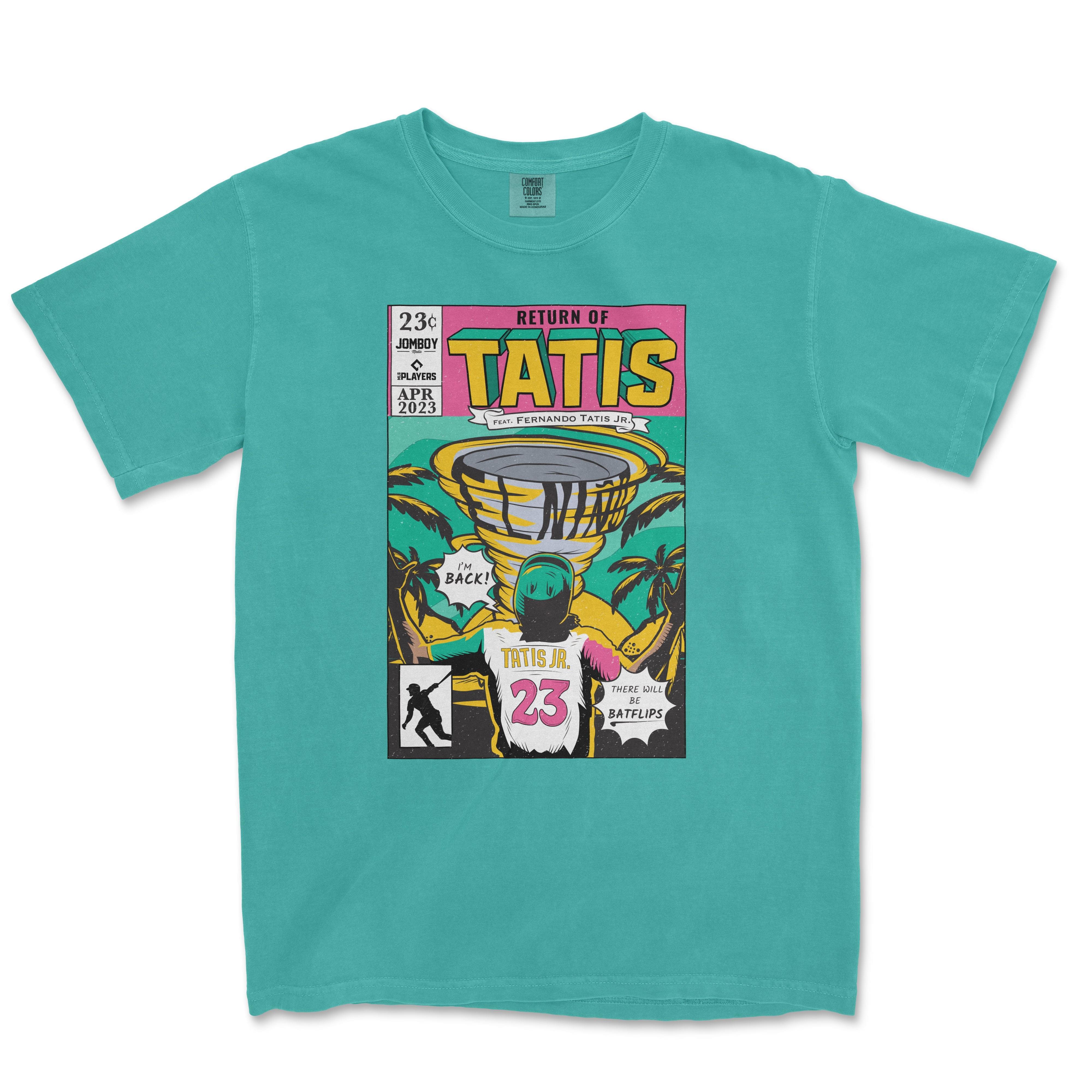 Aqua blue Comfort Colors tee featuring a vibrant comic book style print titled "Return of Tatís" with illustrations related to Fernando Tatís Jr., including baseball elements like bats and a palm tree background, designed for a 2023 release.