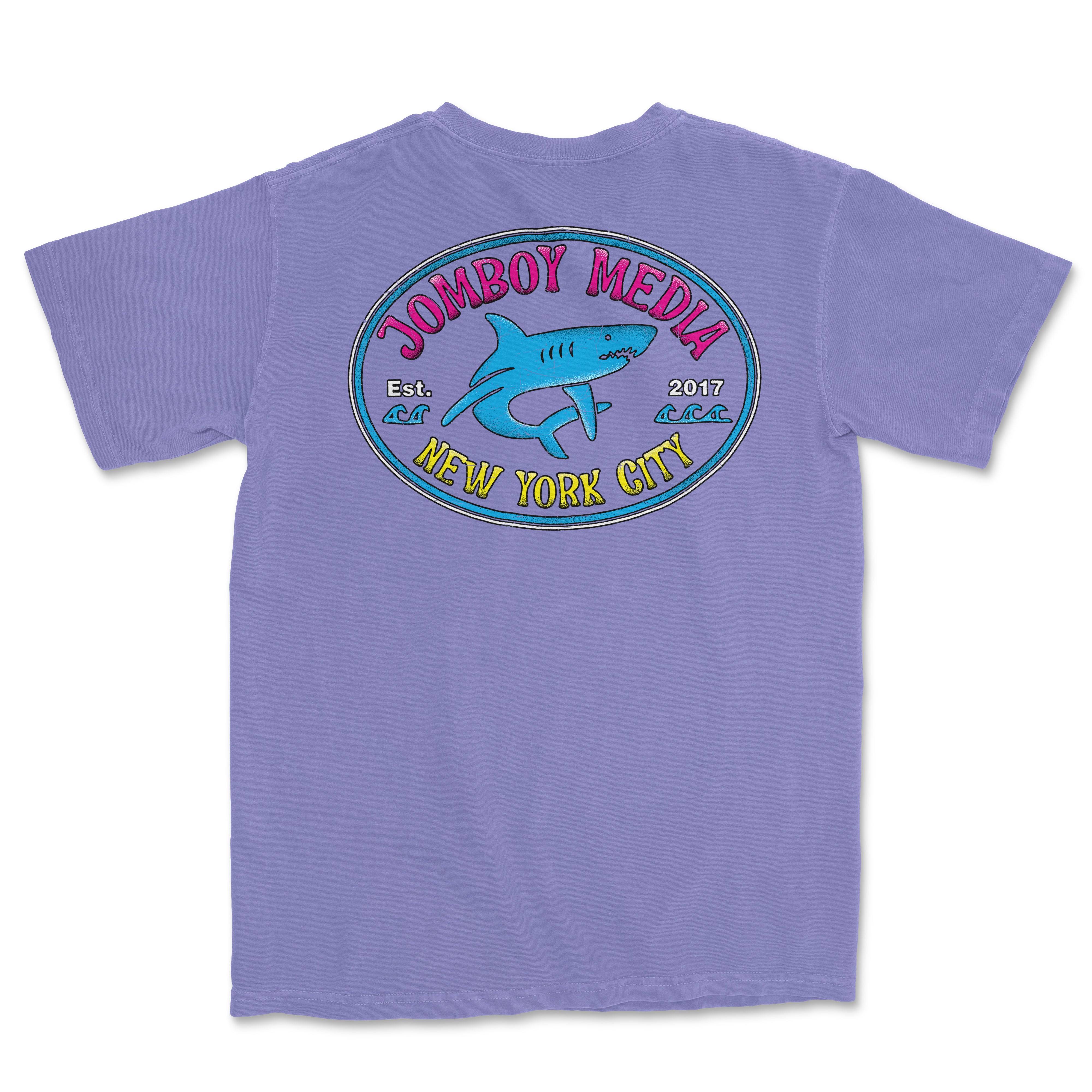 Purple Comfort Colors T-shirt featuring a colorful "Locals Only" design with a shark, "Jombooy Media," and "New York City" text.