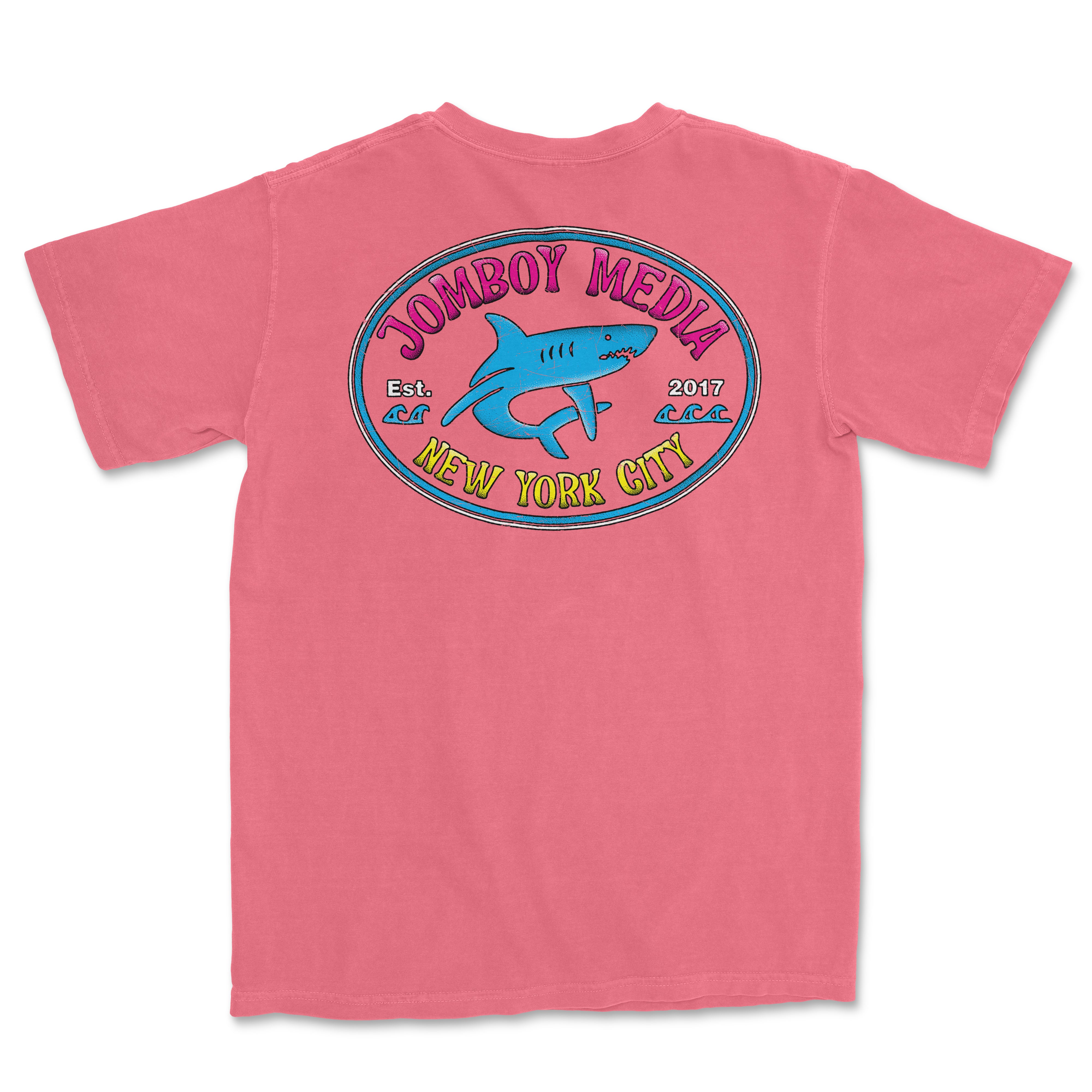Pink Comfort Colors T-shirt featuring a colorful "Locals Only" design with a shark, "JomBoy Media," and "New York City" text.