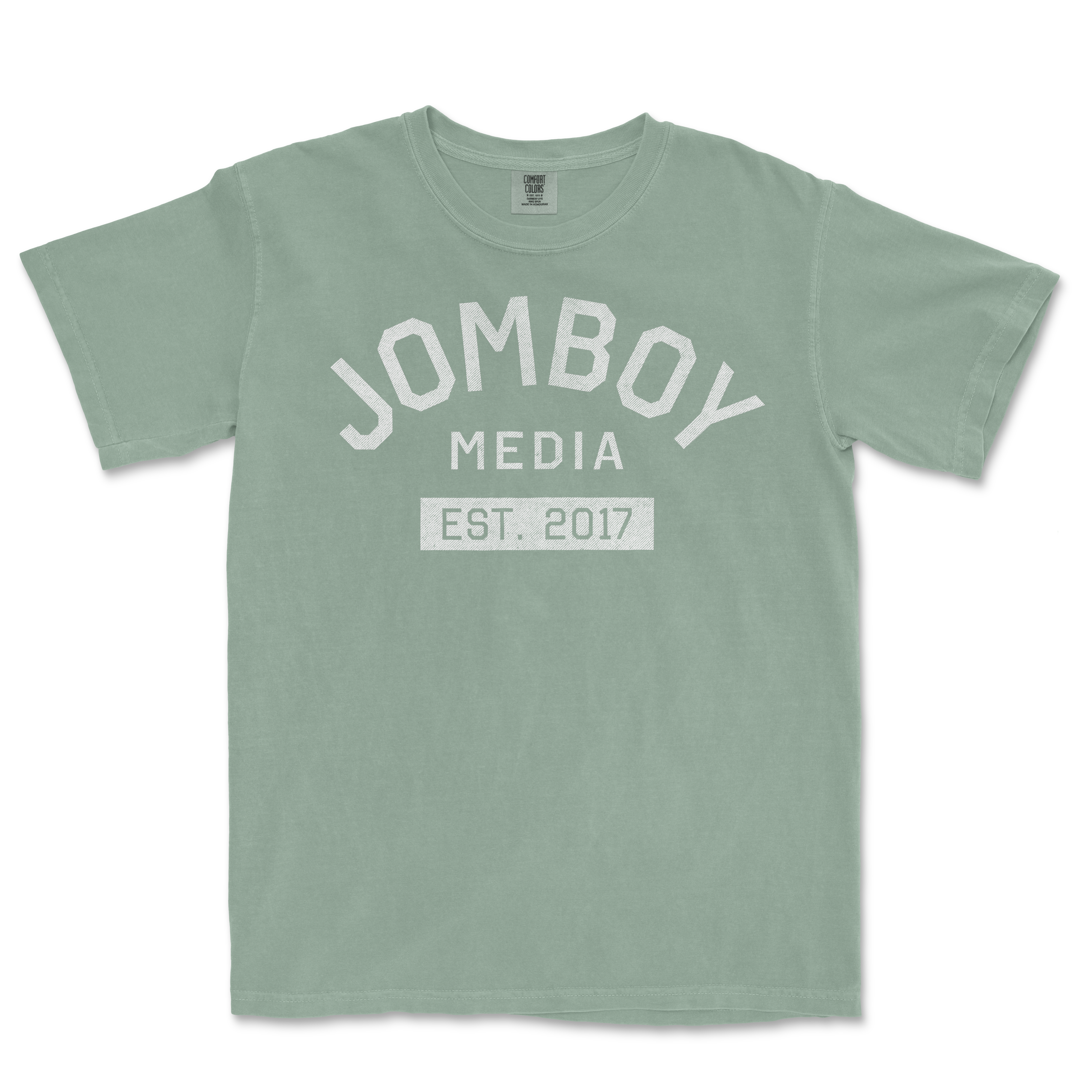 Light green Comfort Colors T-shirt with "Jomboy Media Est. 2017" printed in white on the front.