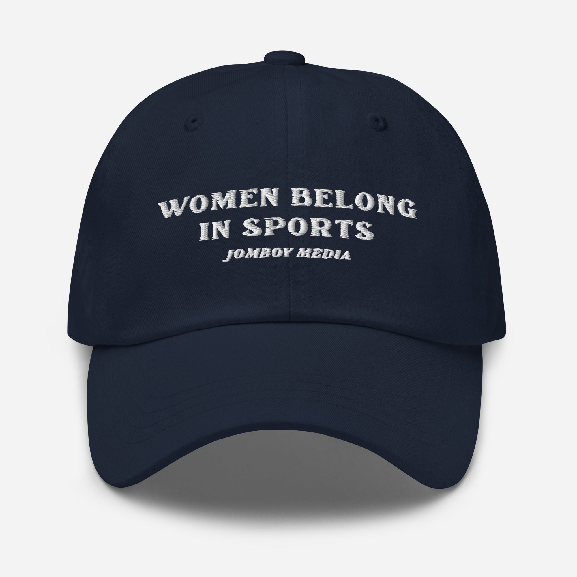 Navy dad hat with embroidered text: "Women Belong in Sports" and "Jomboy Media" underneath, featuring a curved brim.