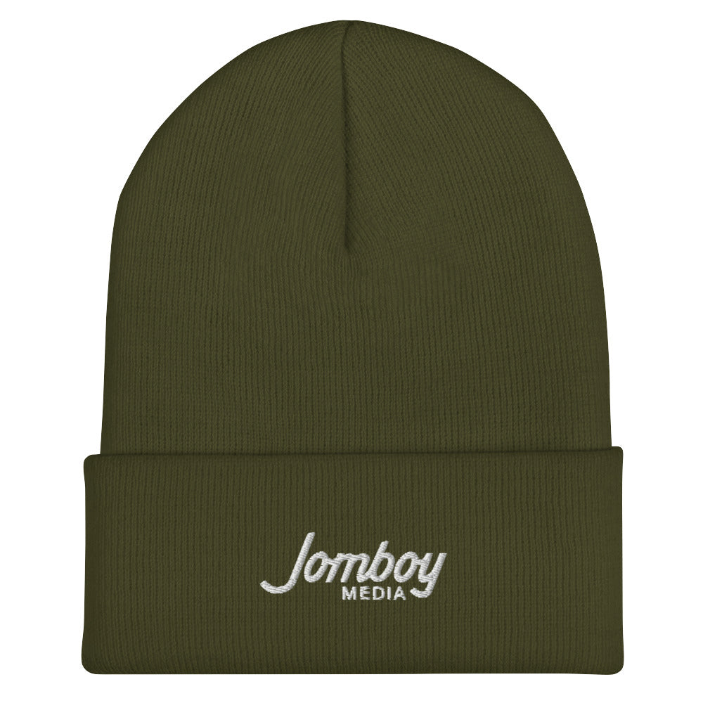 Olive green beanie with folded cuff featuring white embroidered "Jomboy MEDIA" logo.