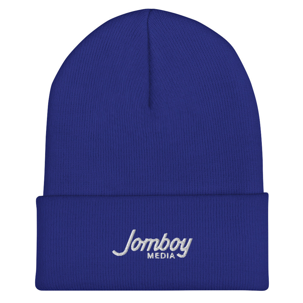 Blue beanie hat with "Jomboy Media" embroidered in white on the front cuff.