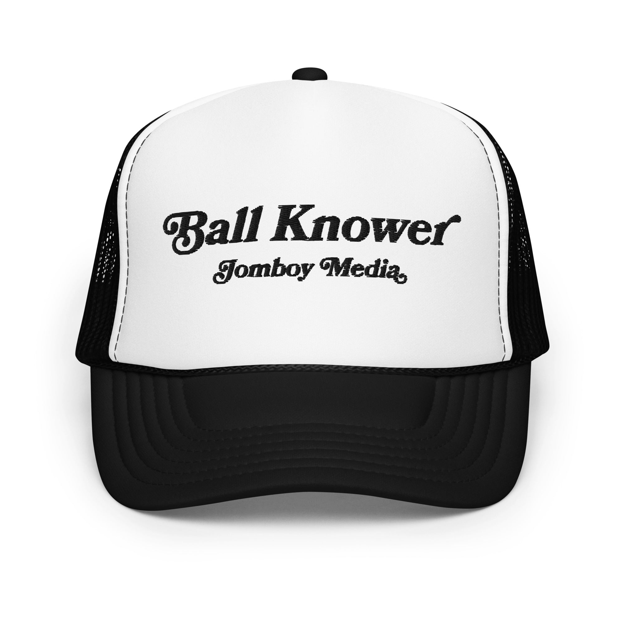 Black and white trucker hat with "Ball Knower" and "Jomboy Media" embroidered on the front panel.