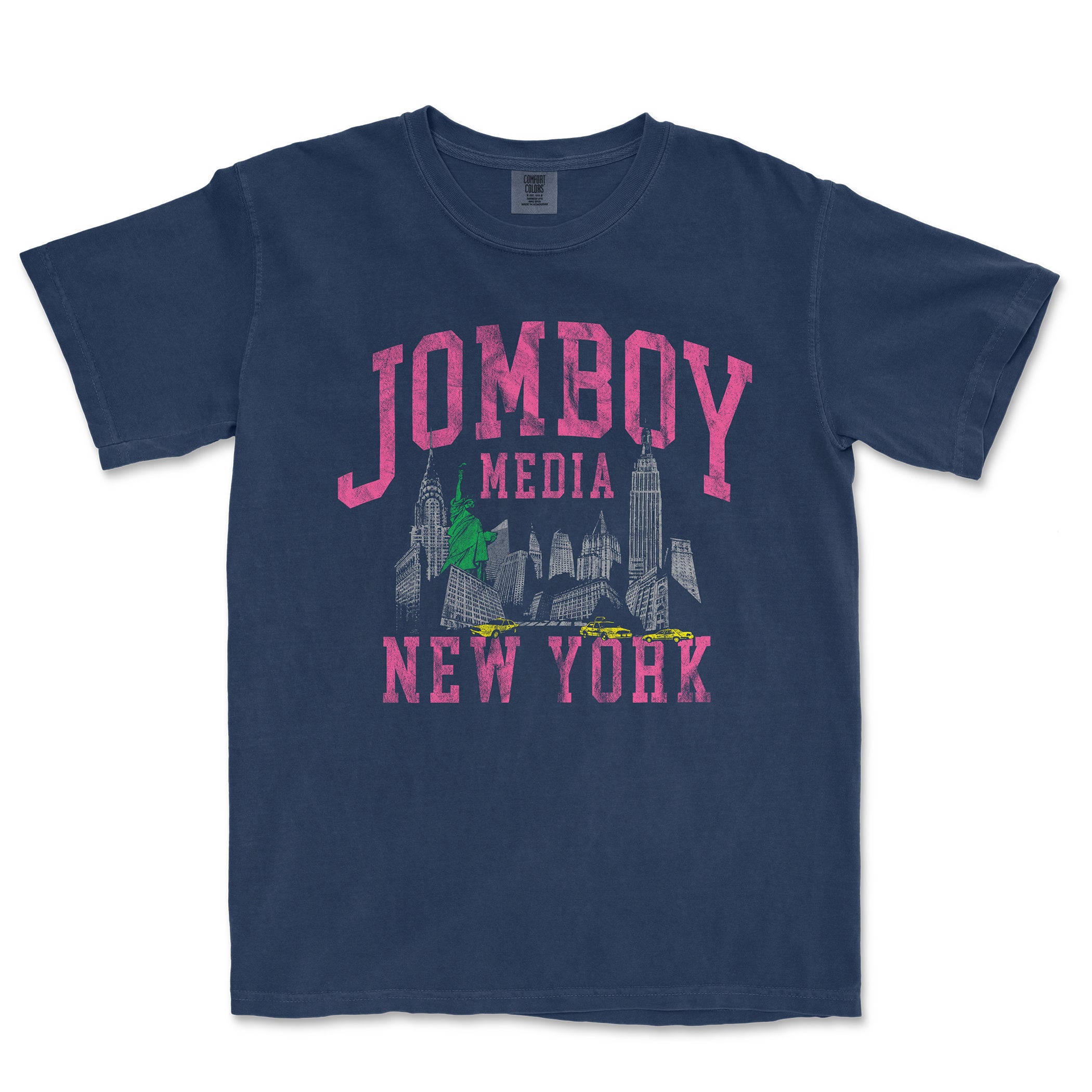 Comfort Colors navy T-shirt featuring a vintage-style graphic of New York City skyline, Statue of Liberty, and yellow taxis with pink and green accents.