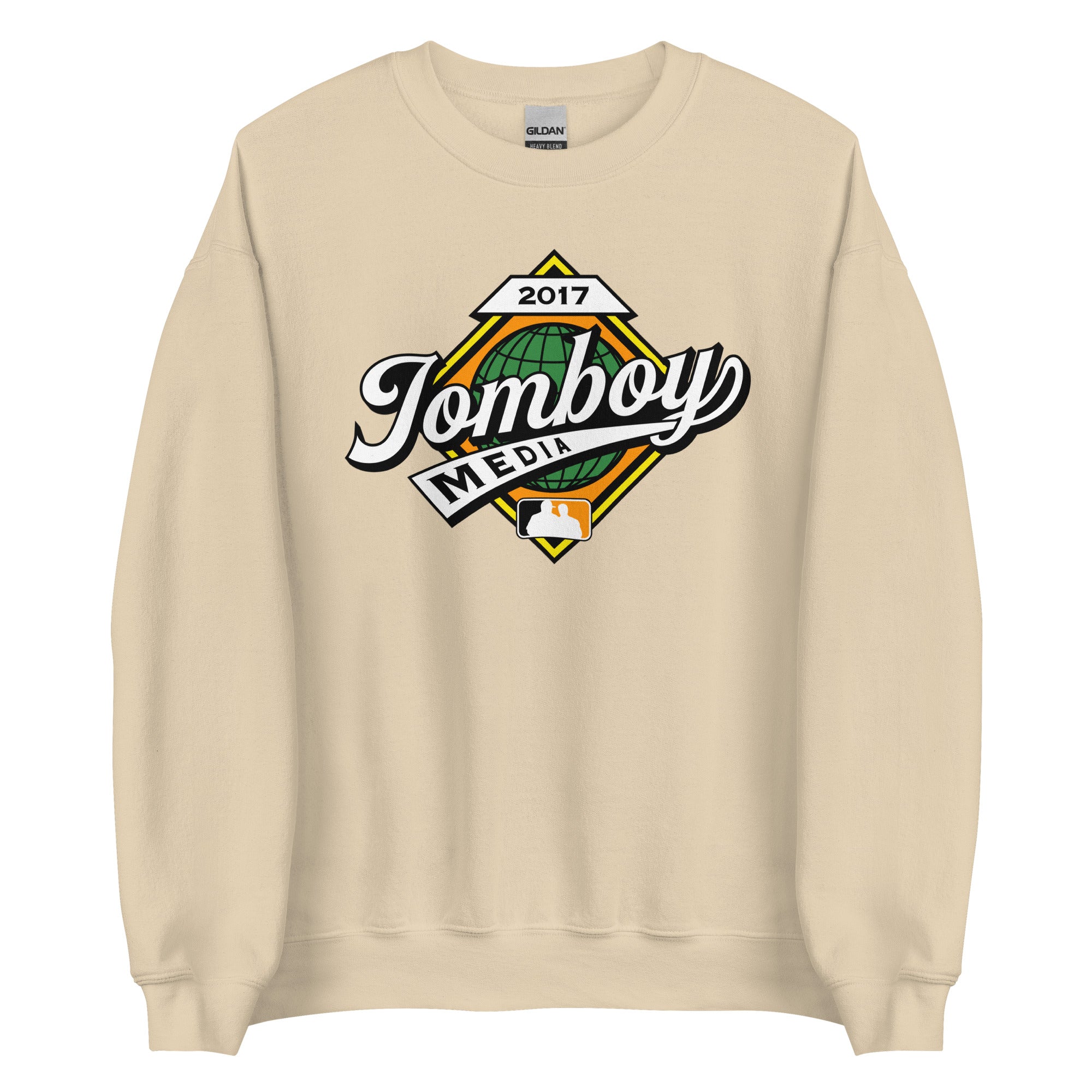 Beige crewneck sweatshirt featuring a colorful "Tomboy Media" logo with a globe, baseball icon, and "2017" text.