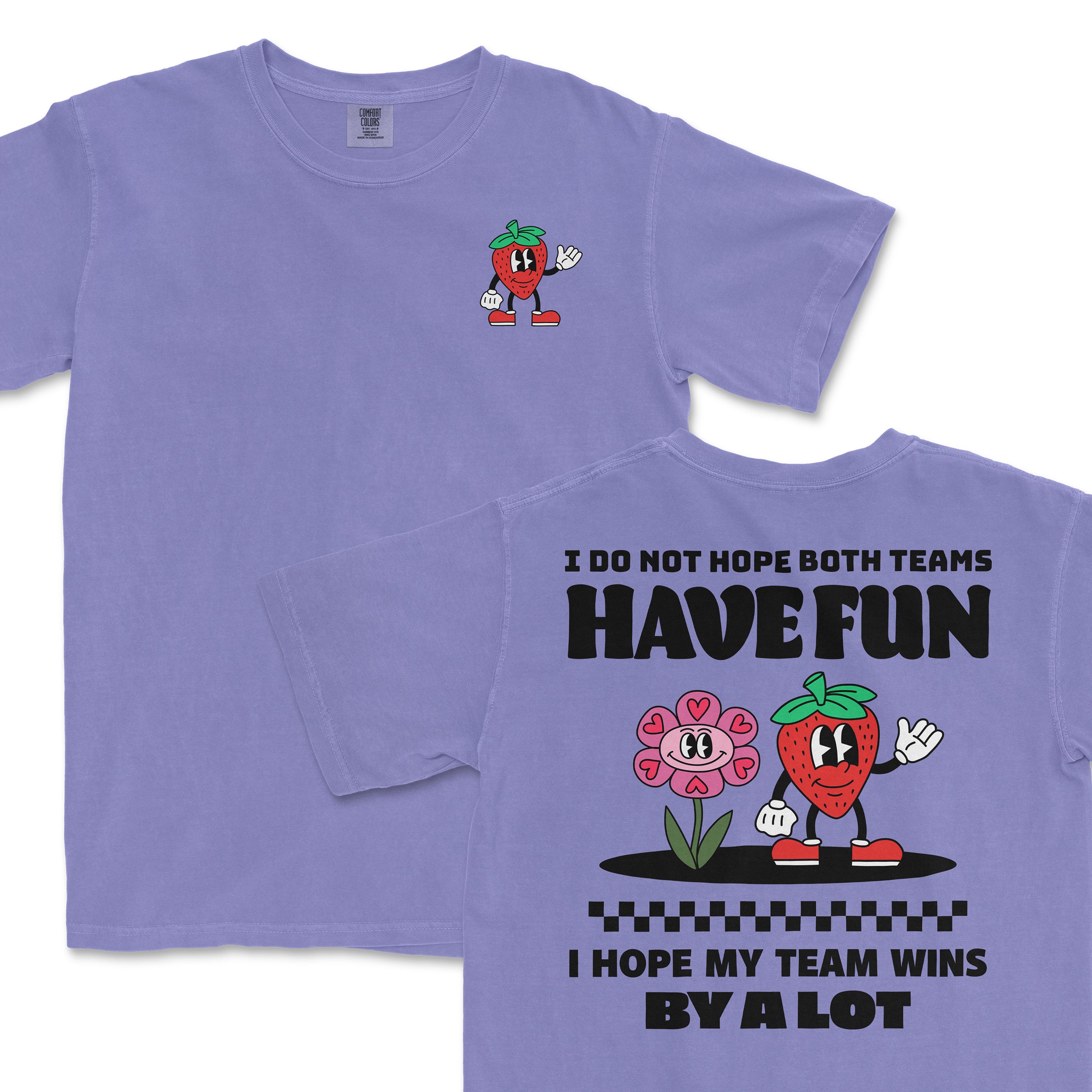 Purple Comfort Colors T-shirt featuring a cartoon strawberry character and a pink flower with the text "I hope my team wins by a lot" and "I do not hope both teams have fun.