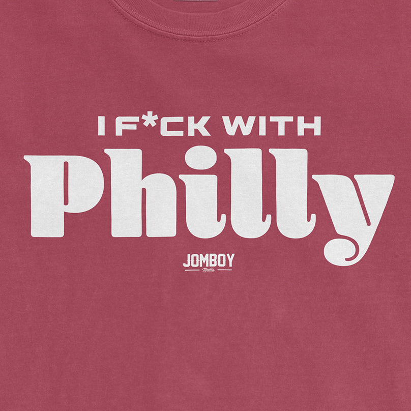 Pink Comfort Colors T-shirt with white text that reads "I F*CK WITH Philly" and a small "JOMBOY Media" logo underneath.