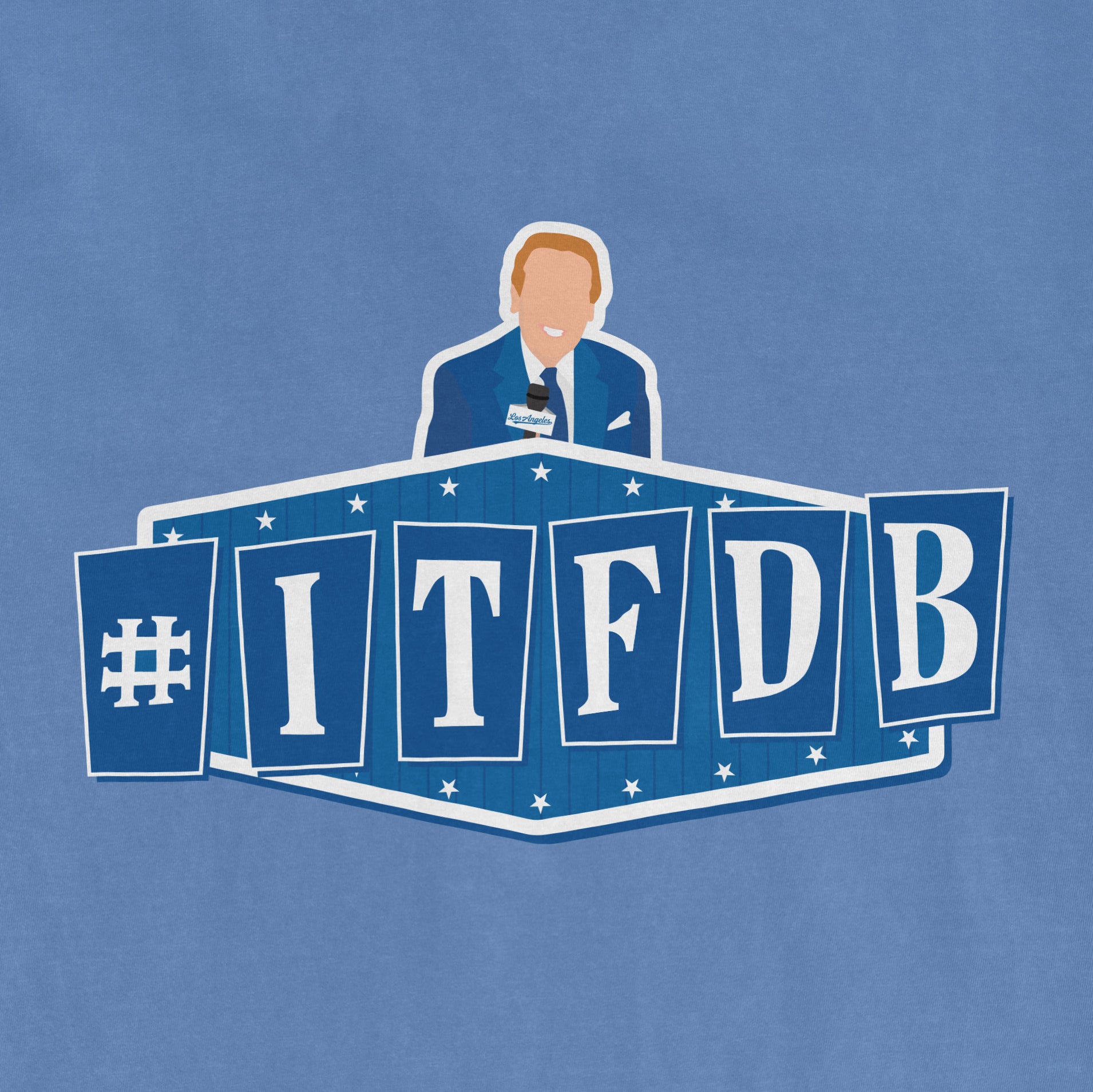 Alt text: "Blue Comfort Colors Tee featuring a graphic print of a man in a blue suit at a podium, behind #ITFDB letter panels in dark blue with white trim and stars."