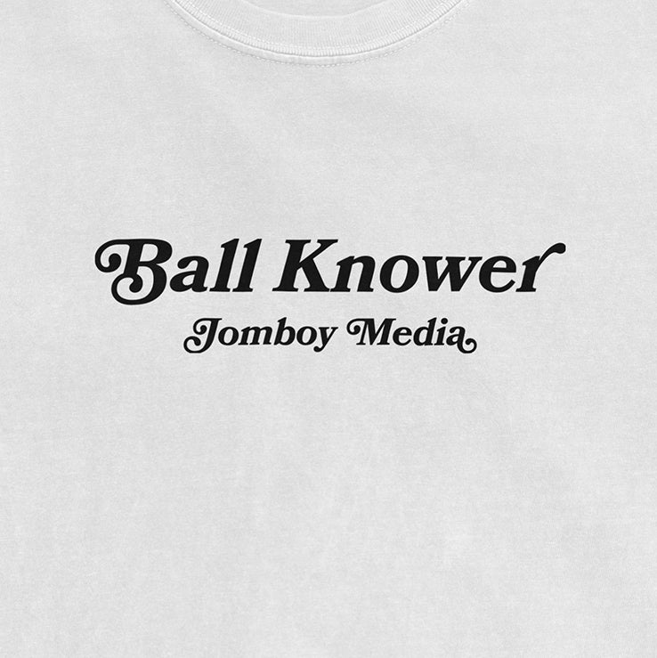 White Comfort Colors T-shirt with black text reading "Ball Knower" and "Jomboy Media" underneath.