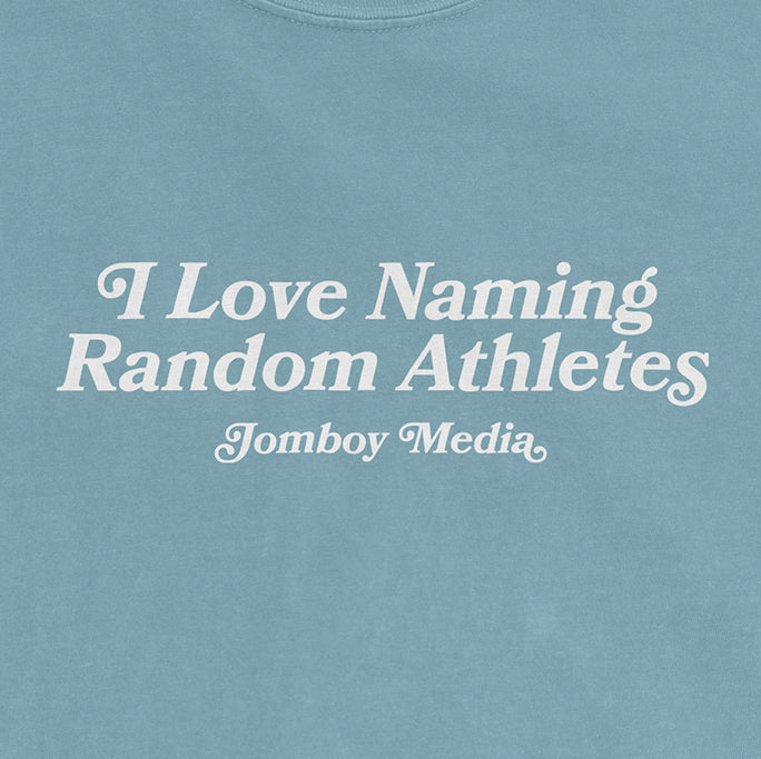 Light blue Comfort Colors T-shirt with white text that reads "I Love Naming Random Athletes" and "Jomboy Media.