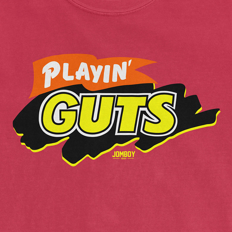 Bright pink shirt featuring a bold graphic logo for "Playin' Guts" with yellow, black, and orange design elements.
