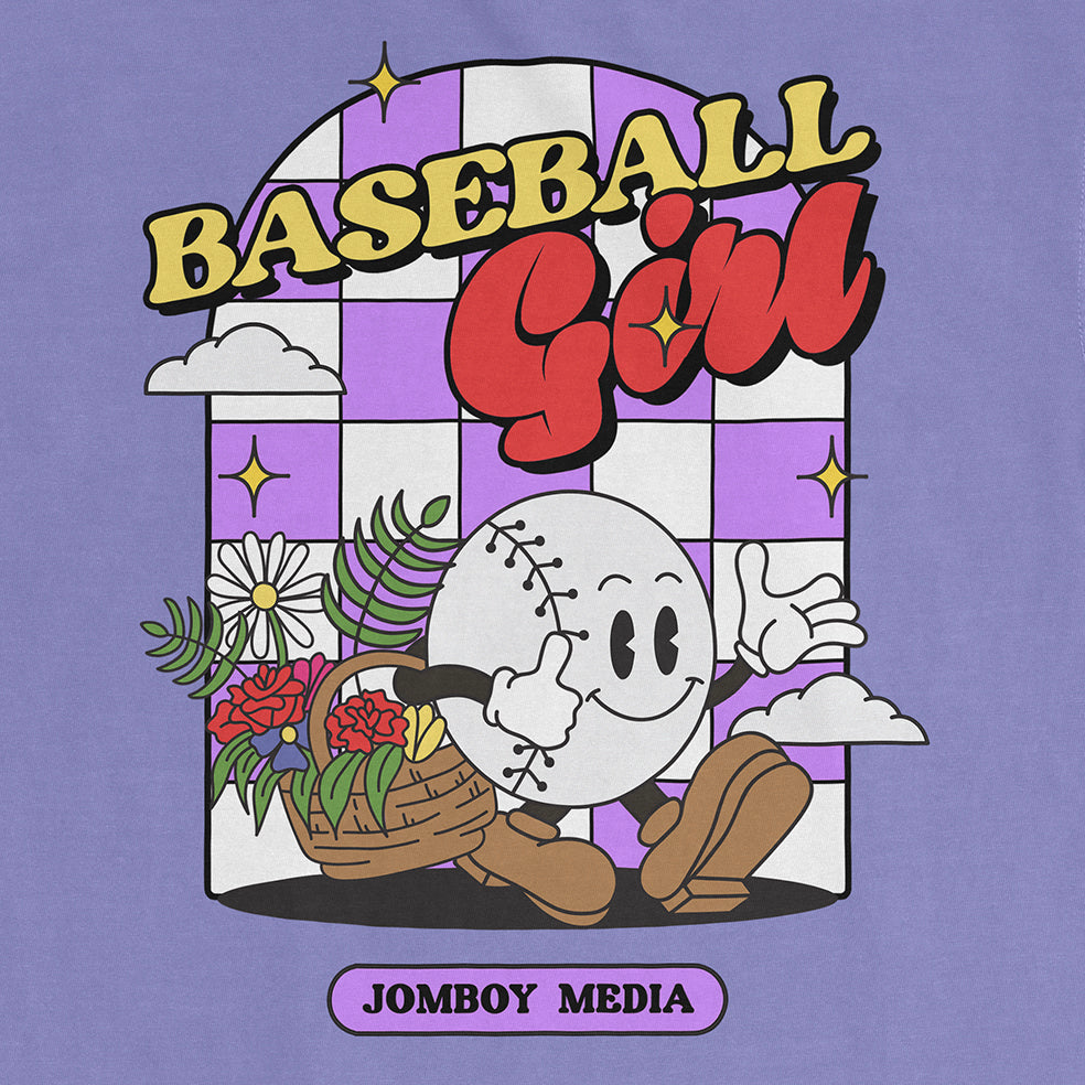 Colorful graphic of a smiling baseball character with a flower basket, set against a purple checkered background, on a Comfort Colors tee.