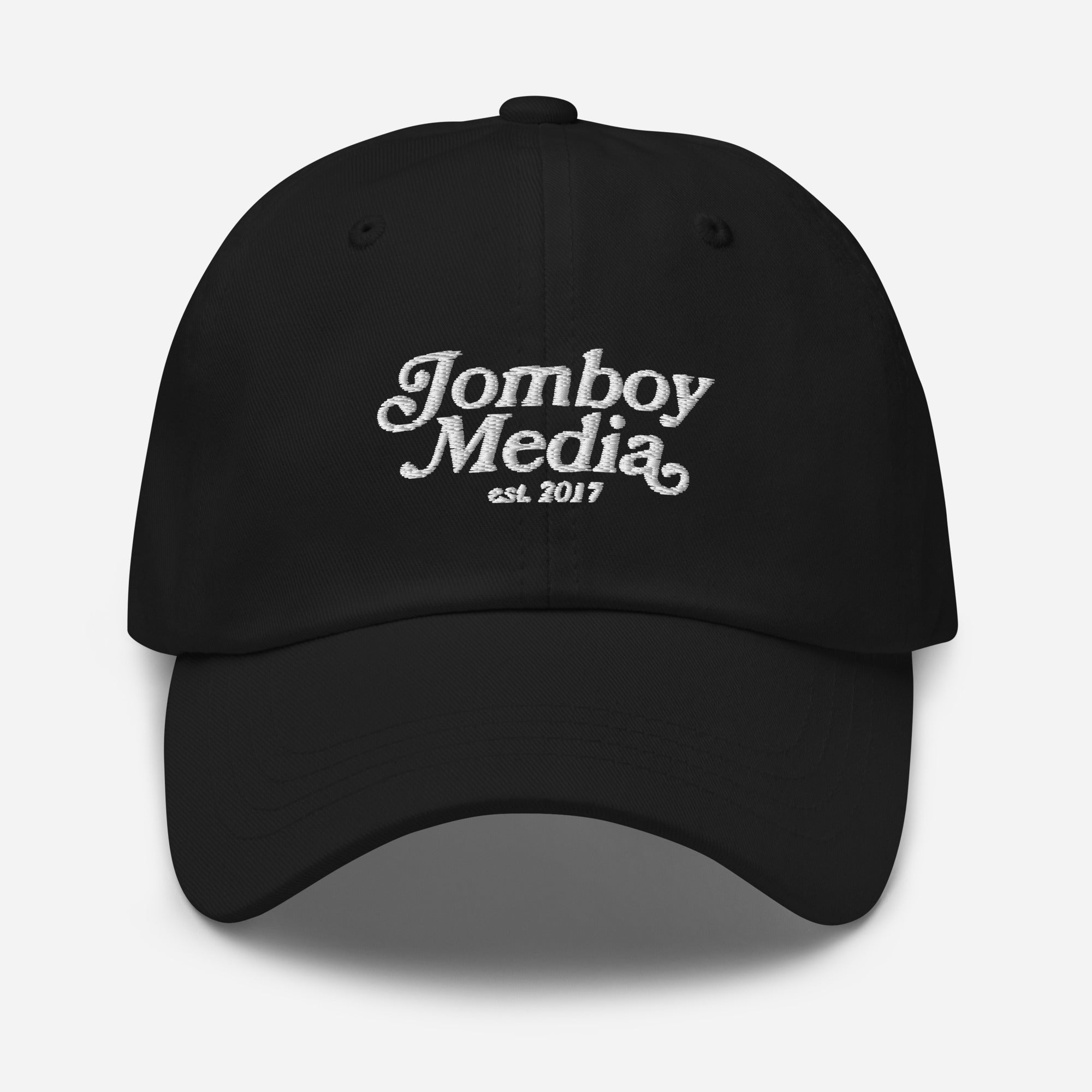 Black dad hat with white embroidered "Jomboy Media" logo and "est. 2017" text on front, adjustable strap, casual style.