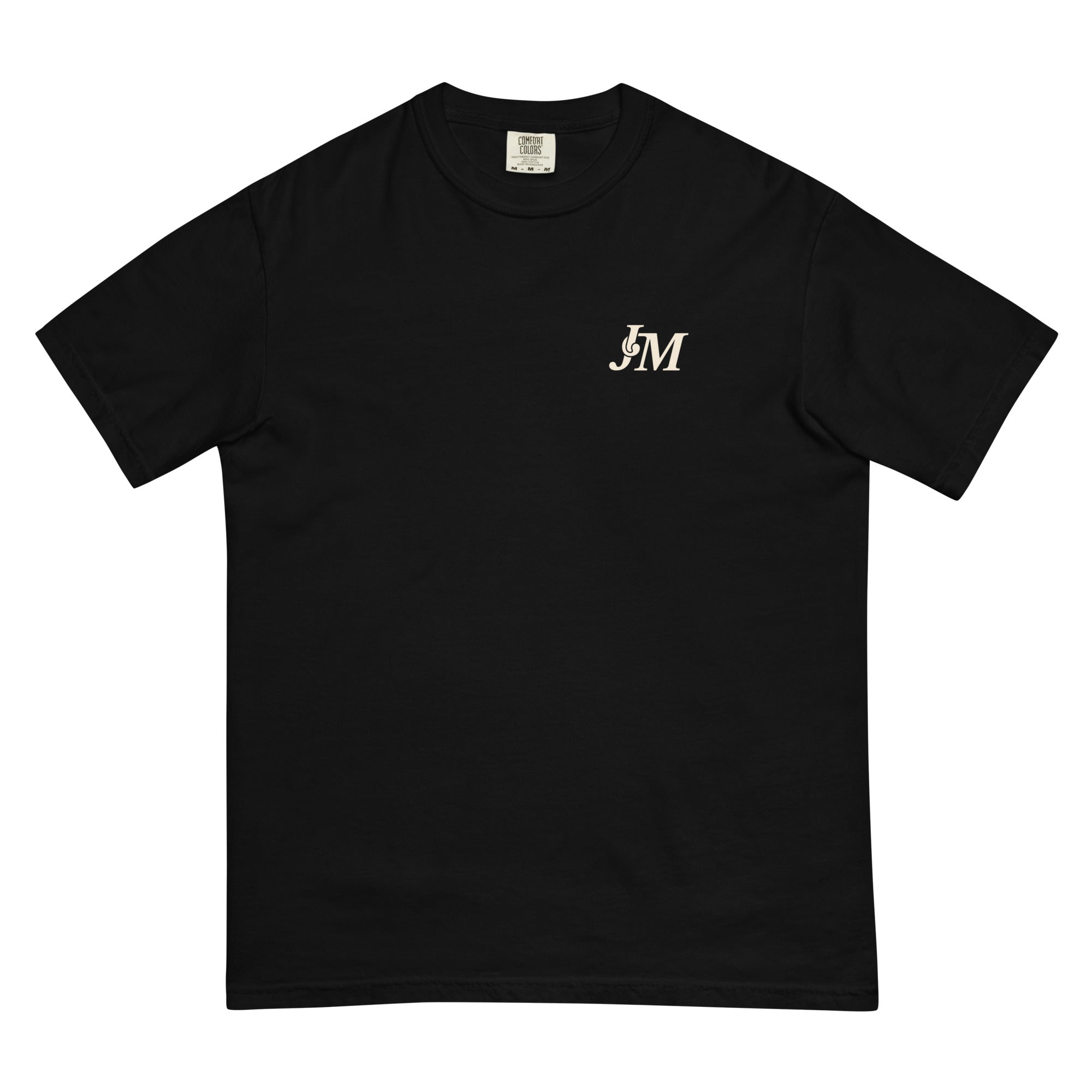 Black T-shirt featuring a small "JM" logo in white on the upper left chest, with a cityscape of New York's skyline in the background.