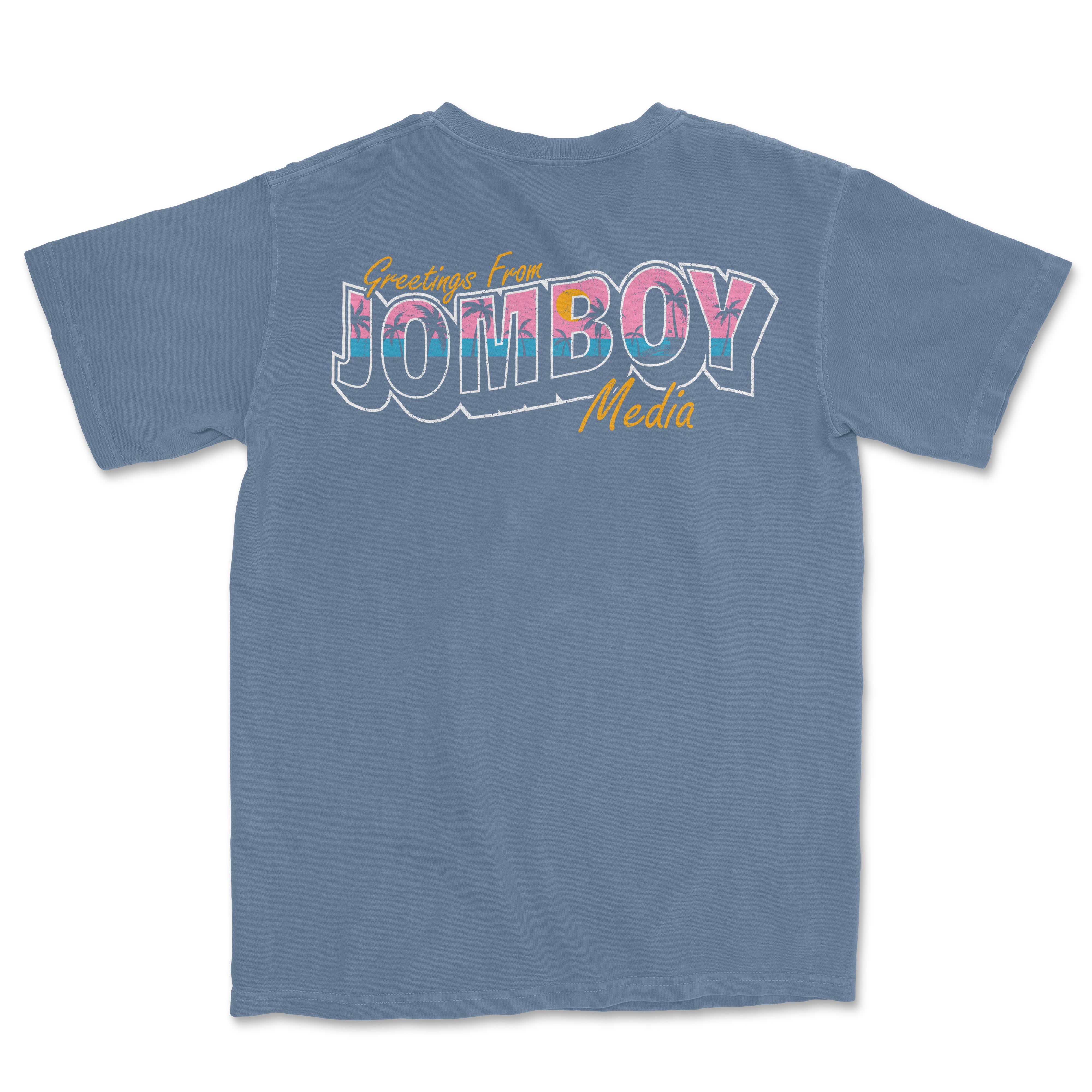 Back of a blue Comfort Colors tee featuring colorful "Greetings from Jomboy Media" text with palm tree accents.