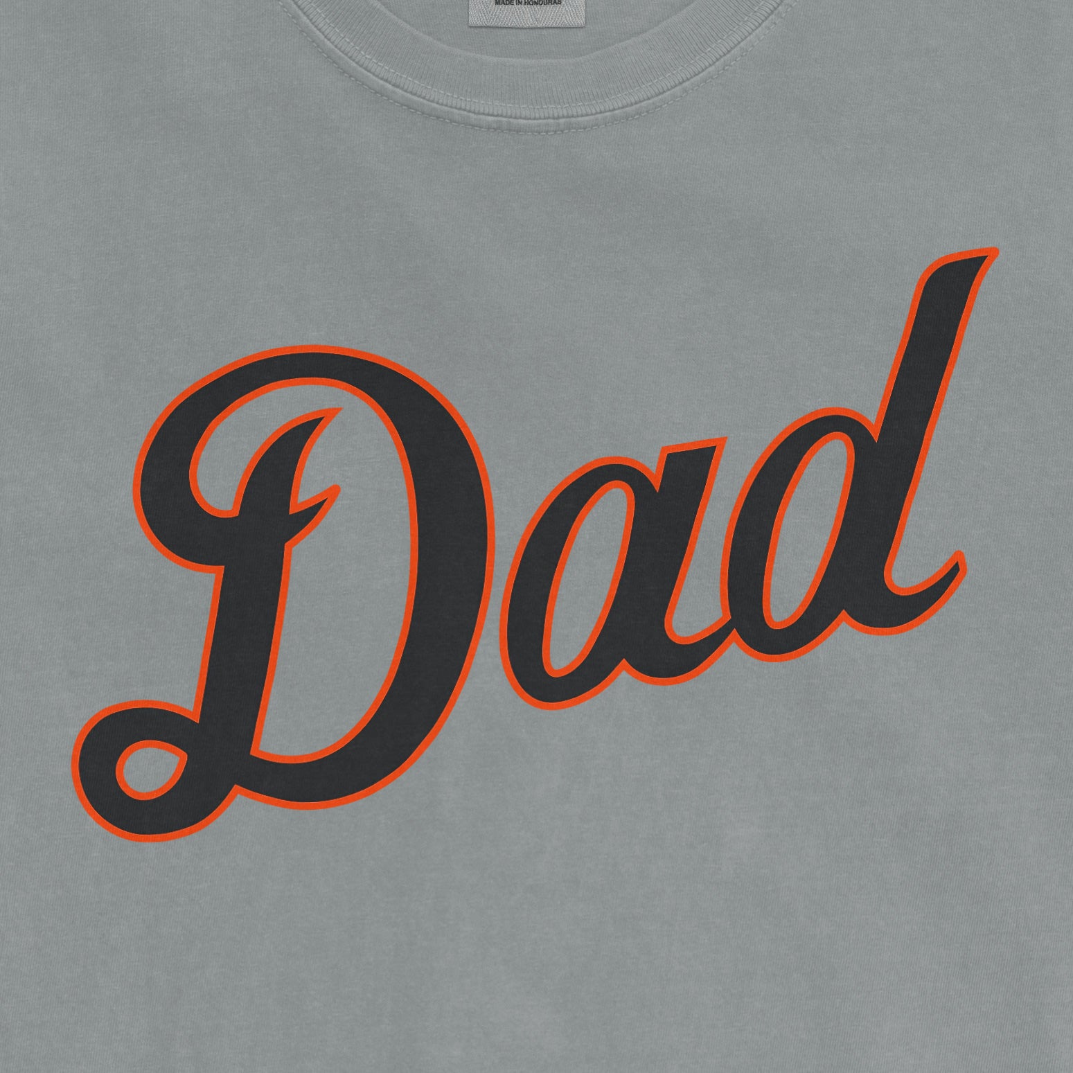 Gray Comfort Colors T-shirt with "Dad" in bold black script outlined in orange, celebrating Detroit baseball dads.