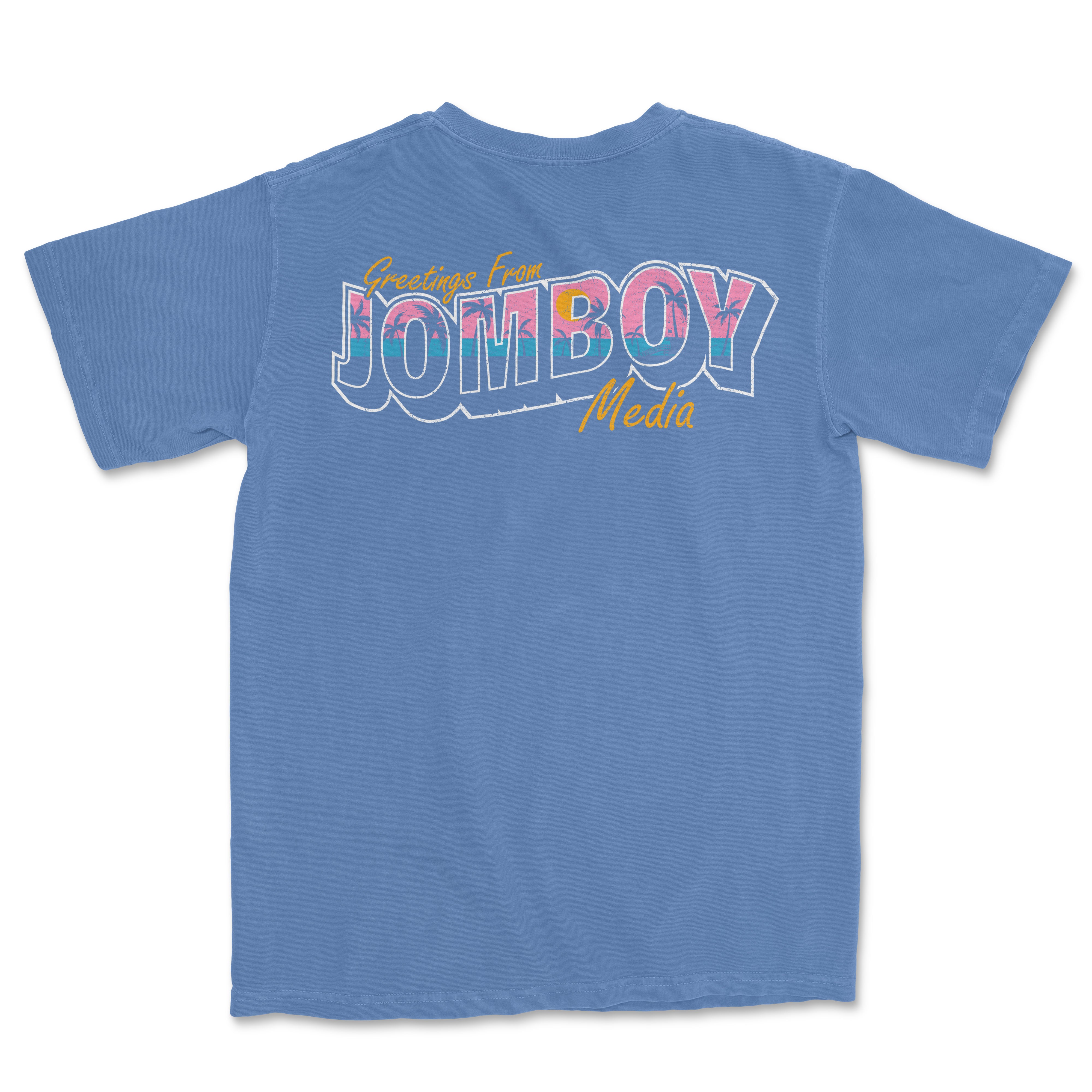 Blue Comfort Colors T-shirt with colorful "Greetings from Jomboy Media" text and yellow "Media" script on the back.