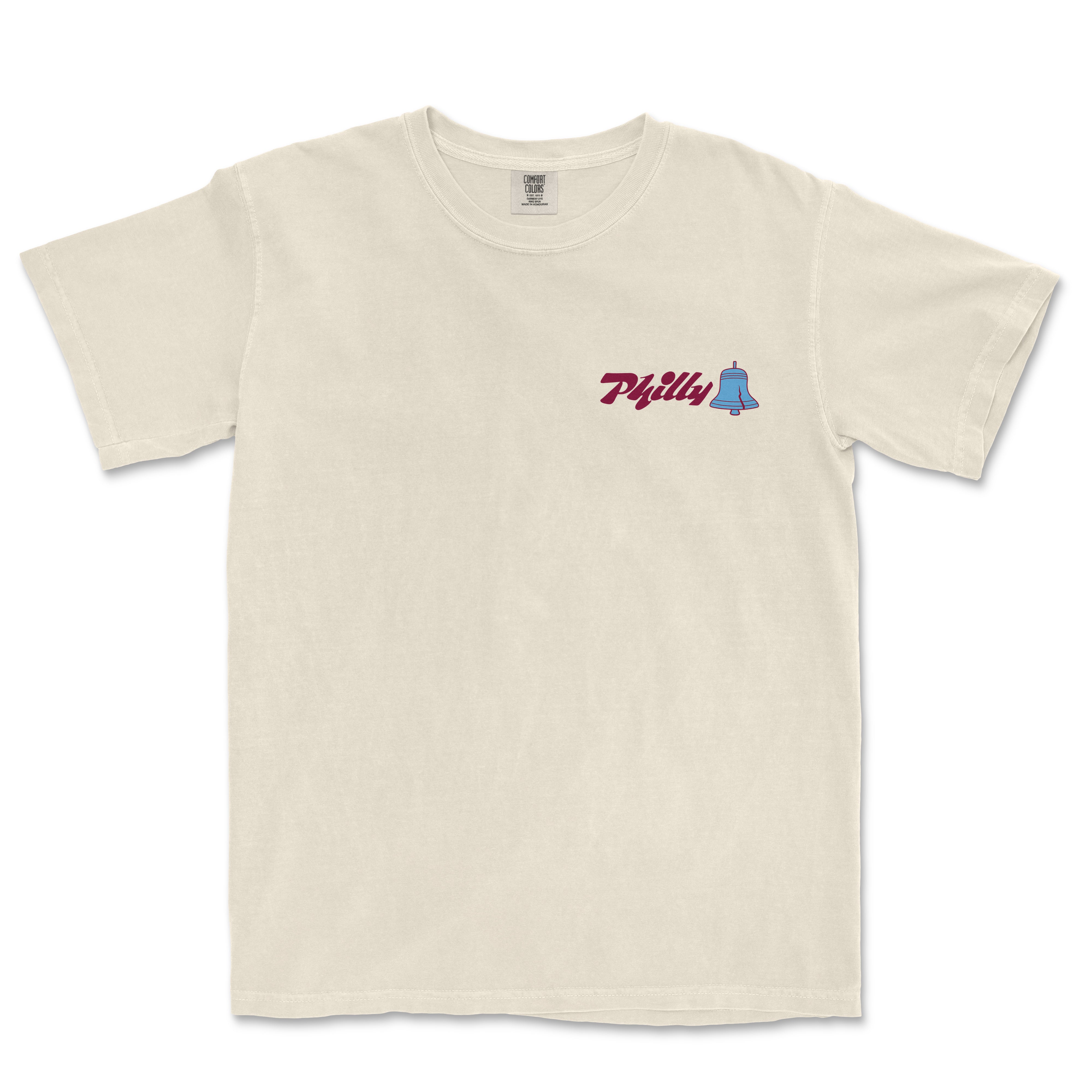 Cream-colored Comfort Colors tee featuring "Philly" text and a small blue bell graphic on the chest.