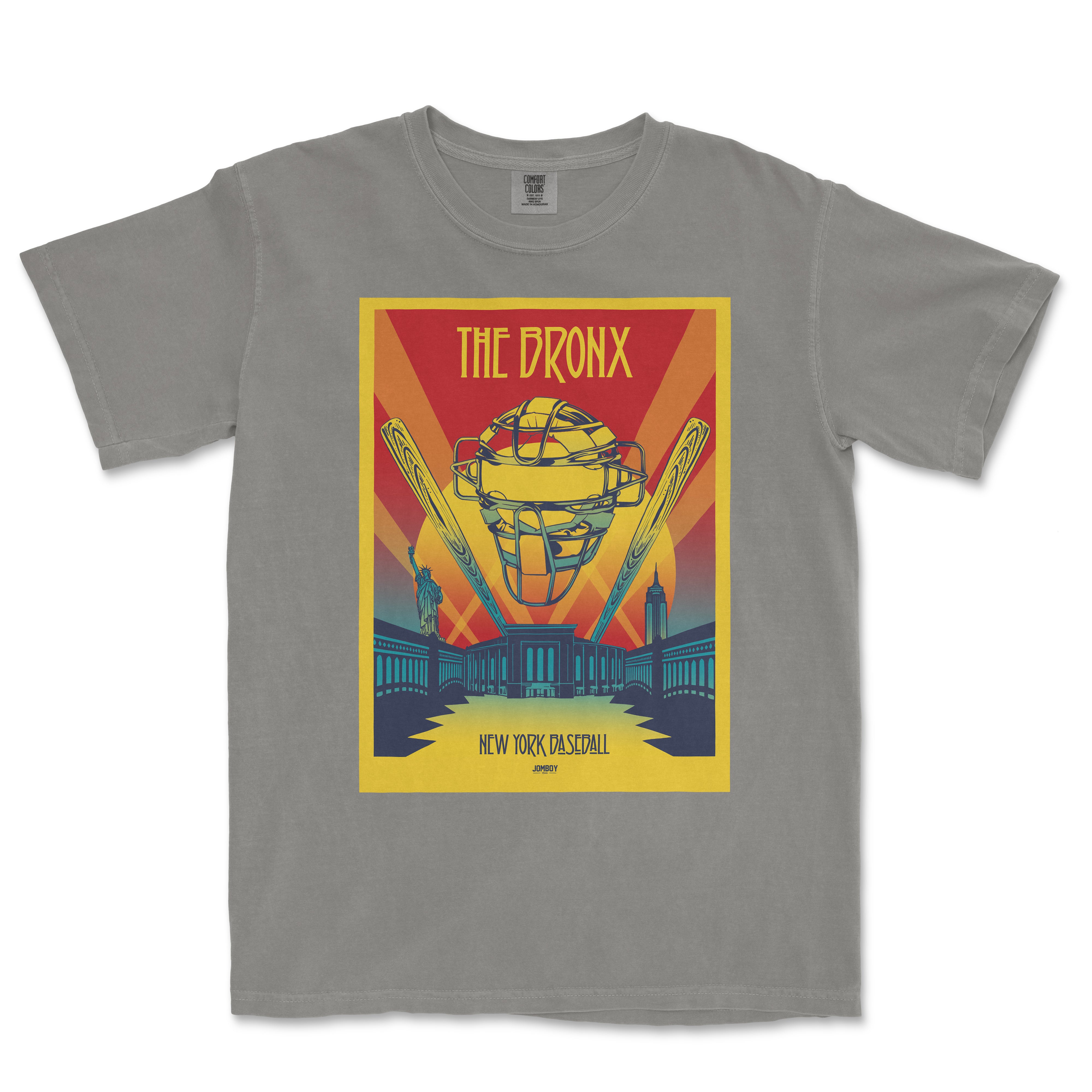 Gray T-shirt featuring a colorful, vintage-style graphic of a baseball helmet, the Statue of Liberty, and cityscape with "The Bronx" text.