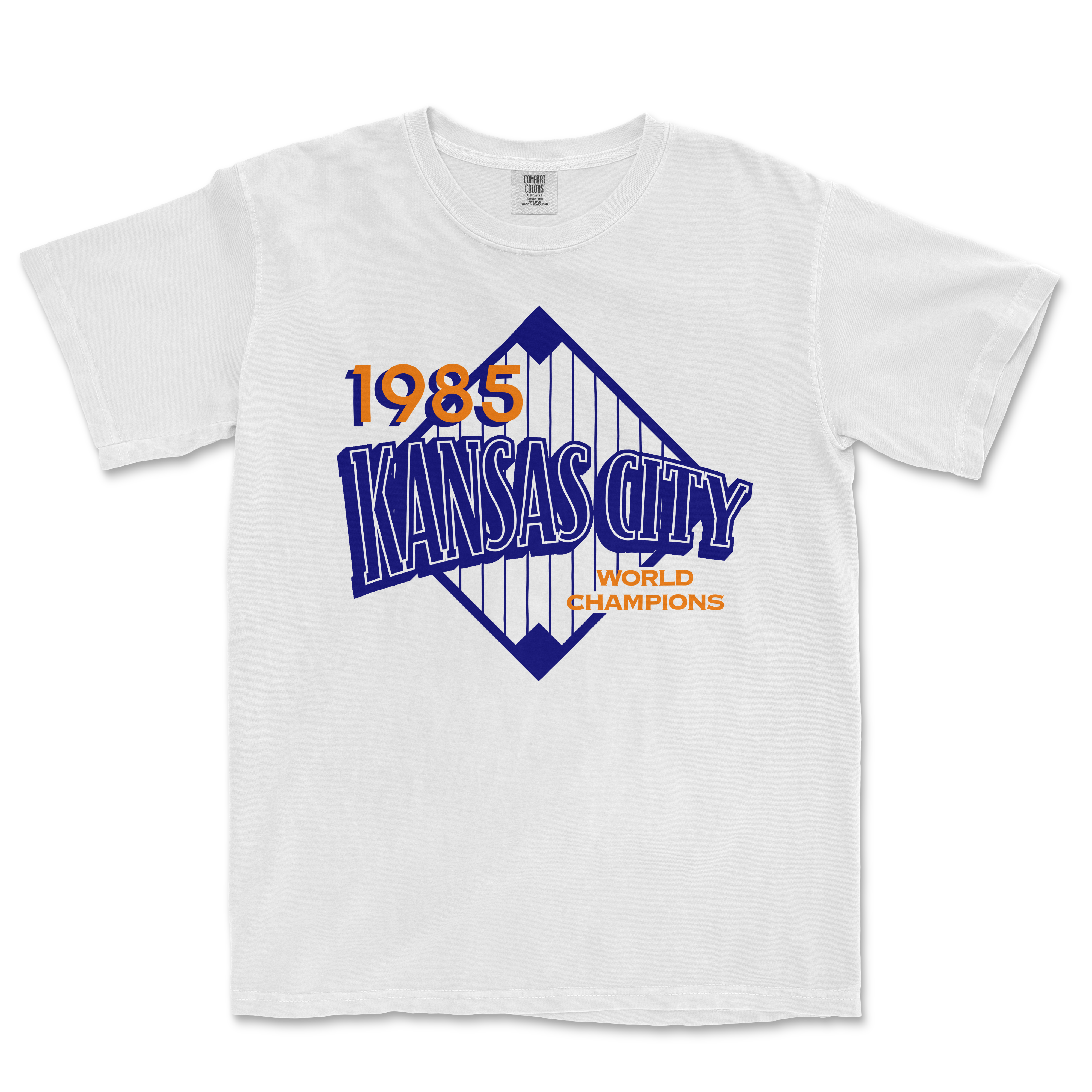 White Comfort Colors T-shirt featuring a vintage Kansas City 1985 World Champions graphic in blue and orange.