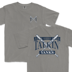 Gray Comfort Colors t-shirt featuring a 'Talkin’ Yanks' graphic with crossed baseball bats and a stylized fence design, with a small logo on the front left chest and a larger version on the back.