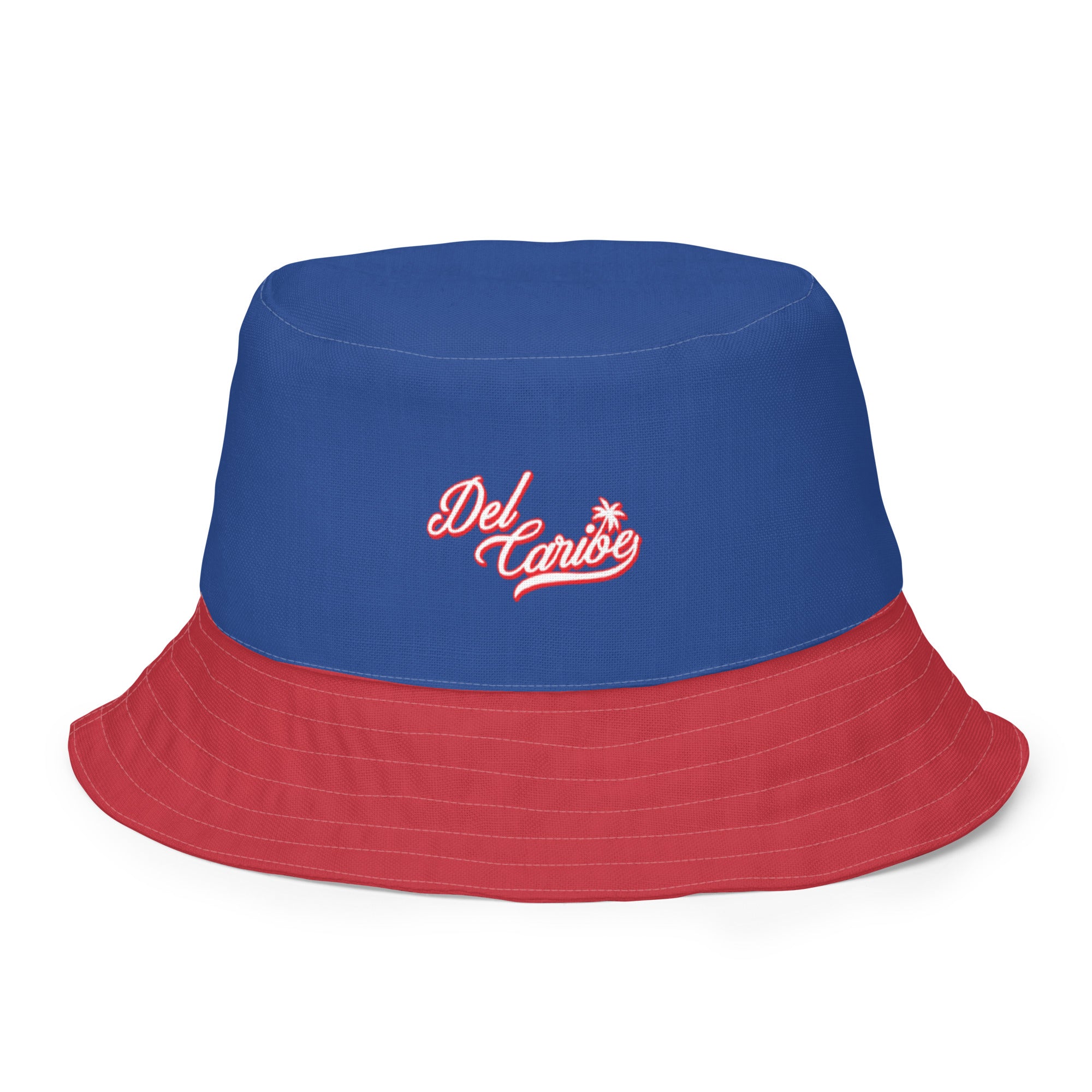 Reversible blue and red bucket hat with "Del Caribe" embroidered logo and a small star, designed for casual wear.