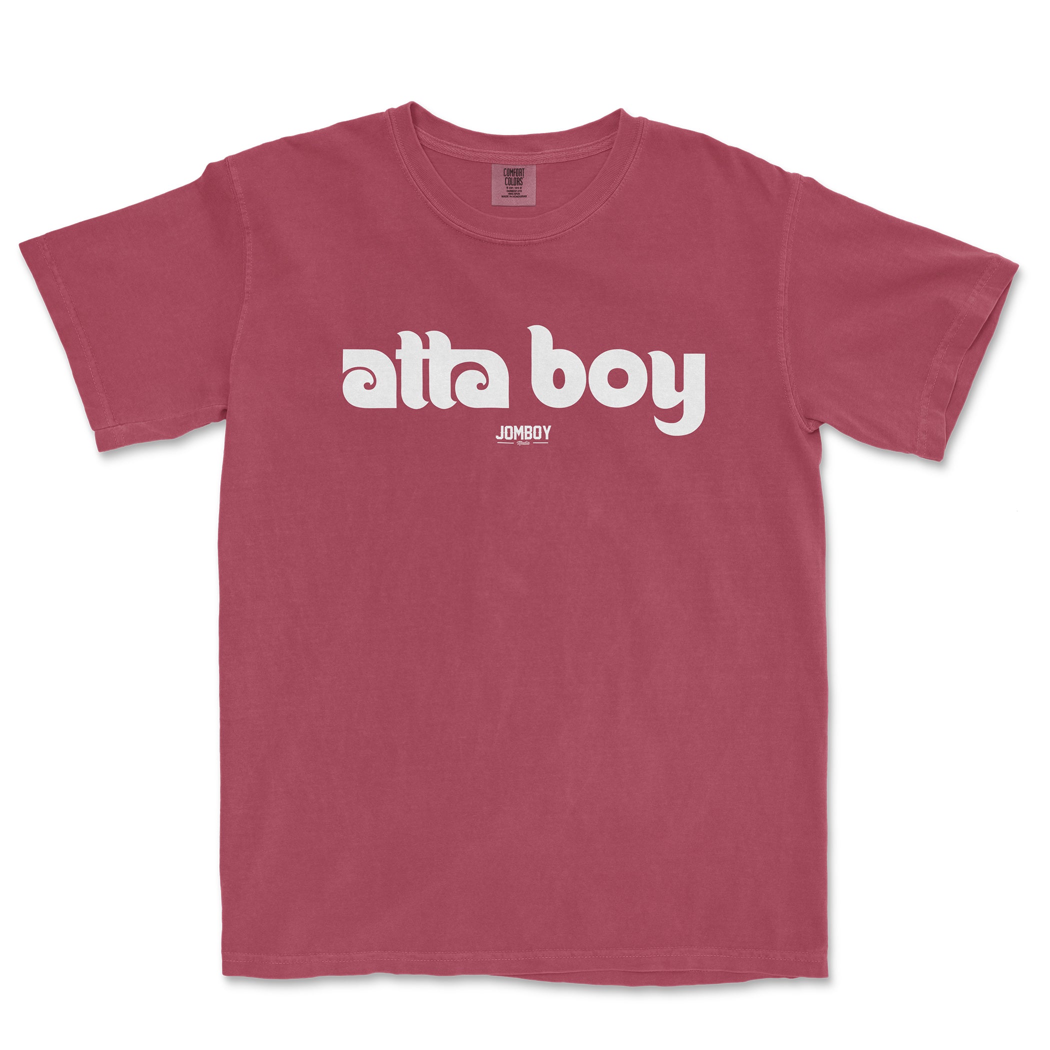 Pink Comfort Colors T-shirt with "atta boy" text in bold white font and small "JOMBOY" logo below.