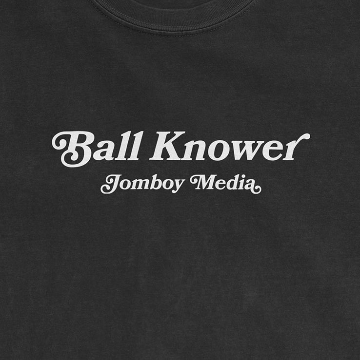 Black Comfort Colors T-shirt with white text reading "Ball Knower" and "Jomboy Media" below it.