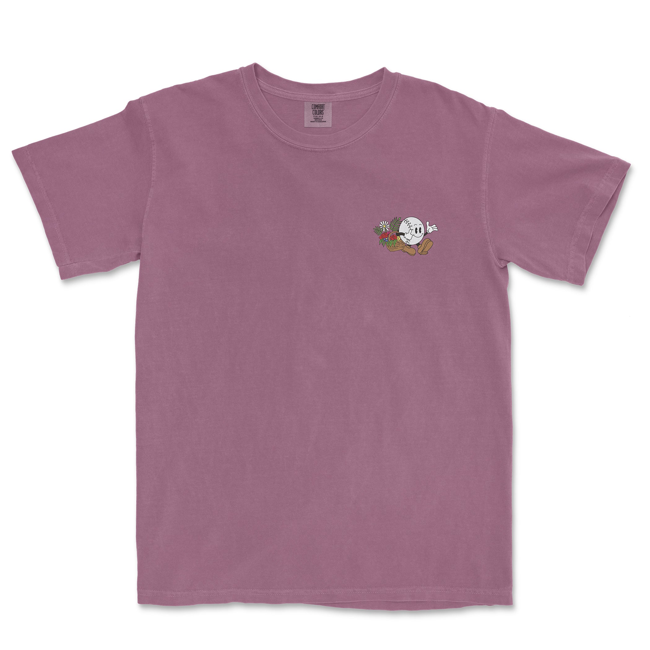 Pink Comfort Colors tee featuring a small baseball girl cartoon with flowers and a baseball glove on the chest.