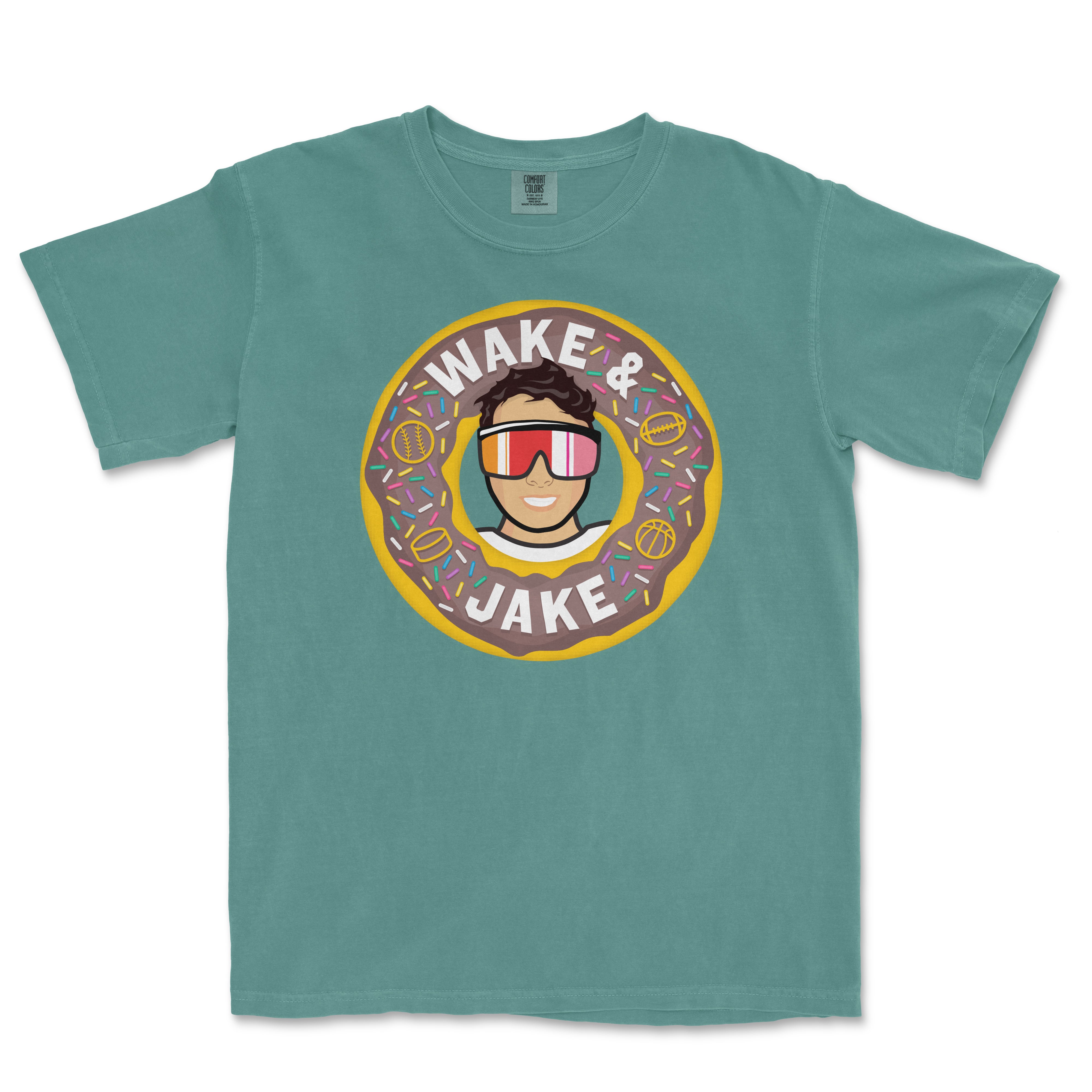 T-shirt featuring a cartoon person wearing sunglasses inside a donut with sprinkles, with the text "Wake & Jake" above and below.