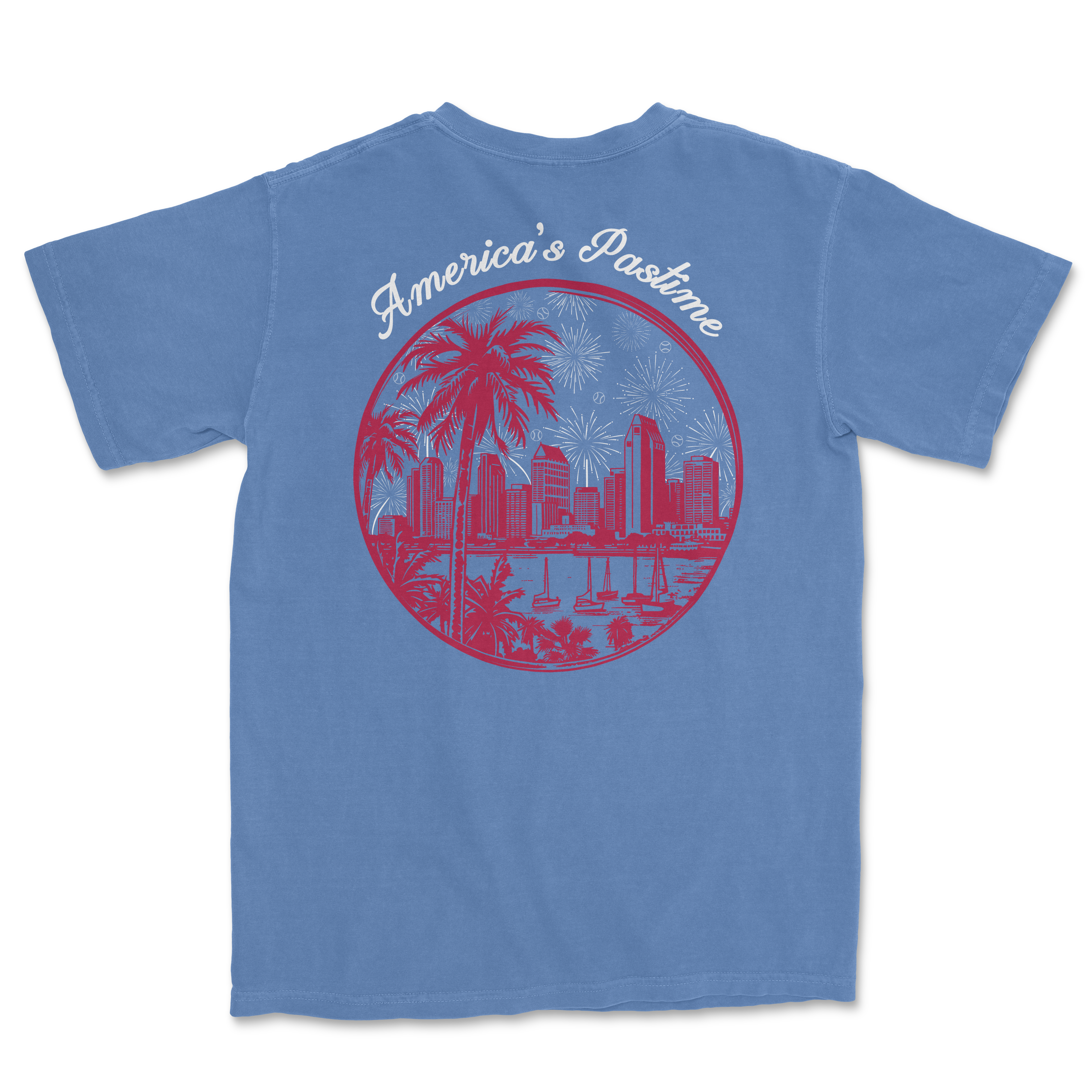 Blue t-shirt featuring a circular graphic with a city skyline, palm trees, and fireworks, labeled America's Pastime.