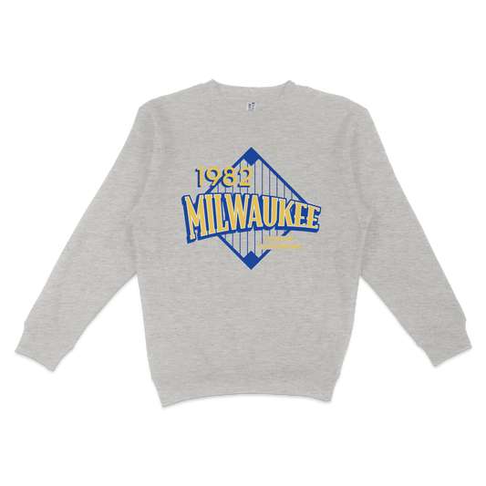 Gray crewneck sweatshirt featuring a vintage Milwaukee 1982 league champions graphic with blue and yellow text and a stylized bridge design.
