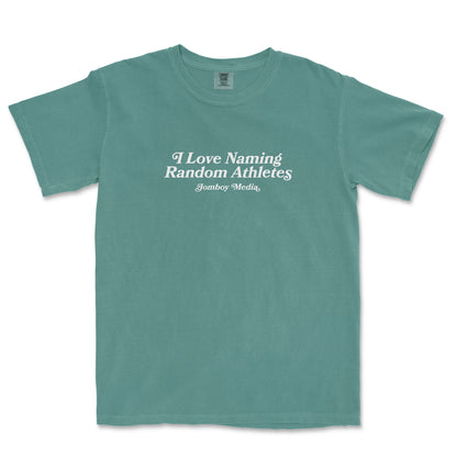 Comfort Colors tee with white text that reads "I Love Naming Random Athletes" and "Jomboy Media" underneath, in a casual, relaxed fit.