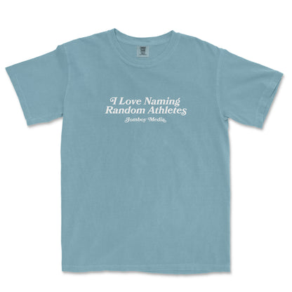 Light blue Comfort Colors T-shirt with white text that reads "I Love Naming Random Athletes" and "Jomboy Media" underneath.