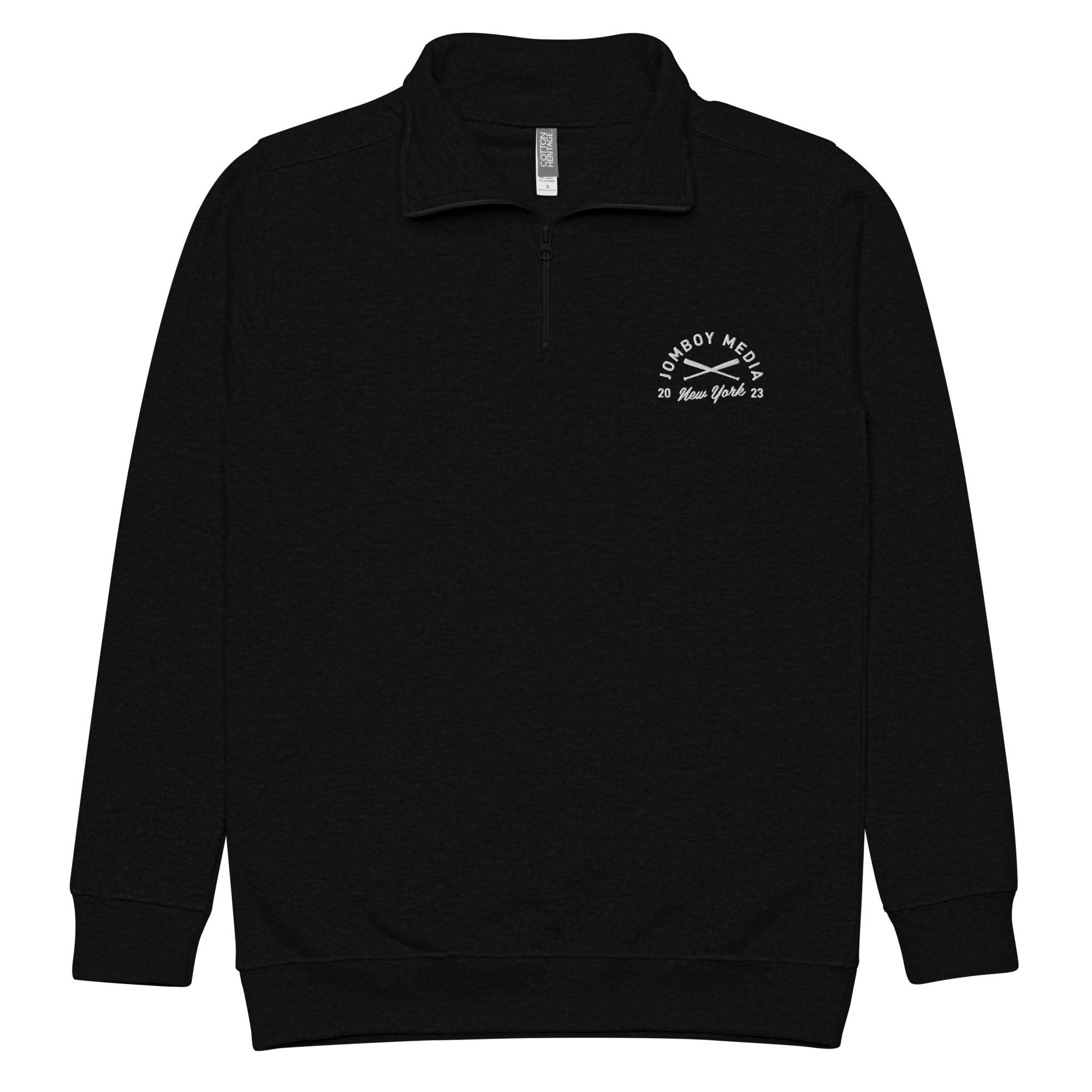 Black fleece quarter-zip jacket with a small white JM Coat of Arms logo on the left chest, featuring "Jomboy Media" and "New York 23.