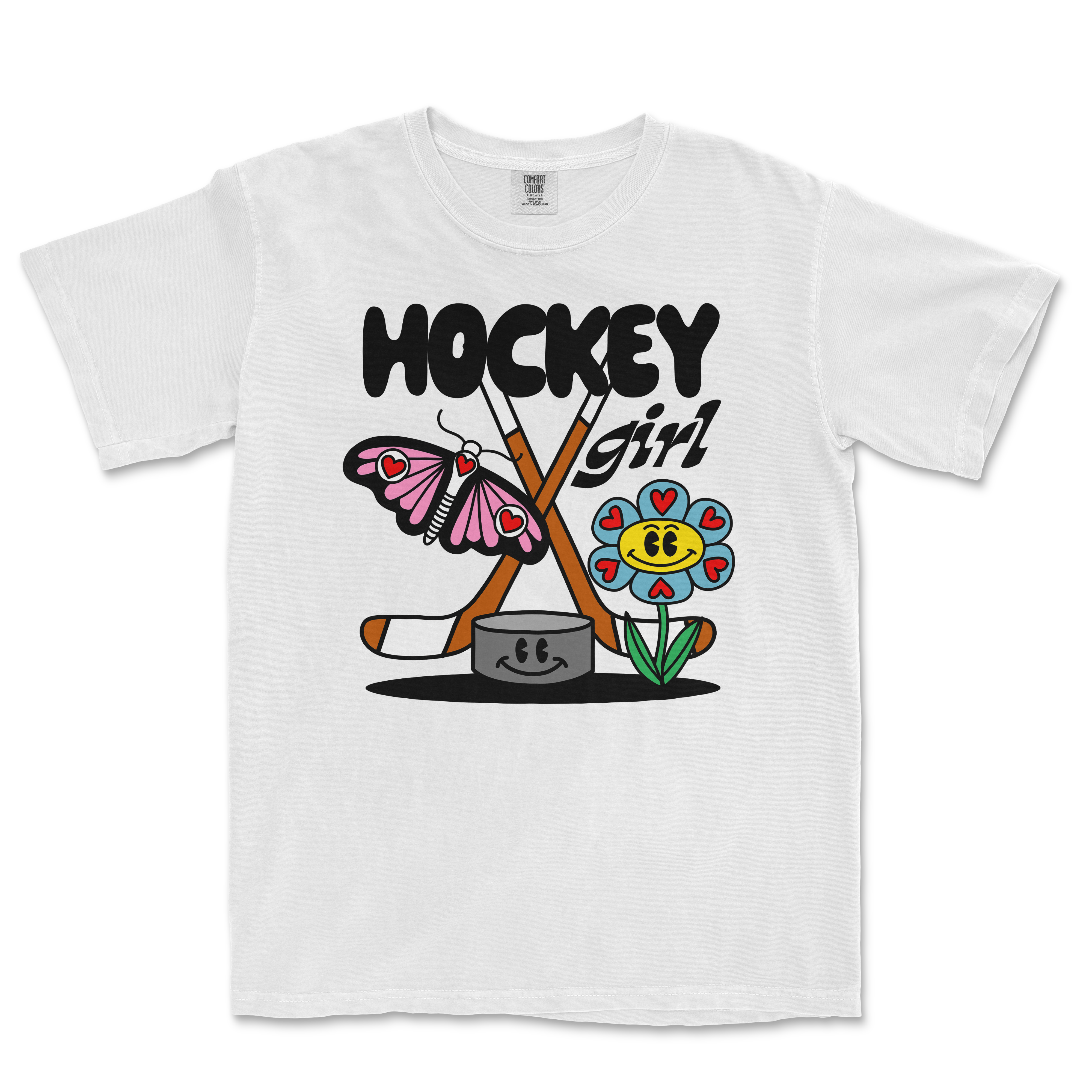White Comfort Colors tee featuring a colorful cartoon design of a butterfly, flower, hockey sticks, and the text "Hockey Girl.